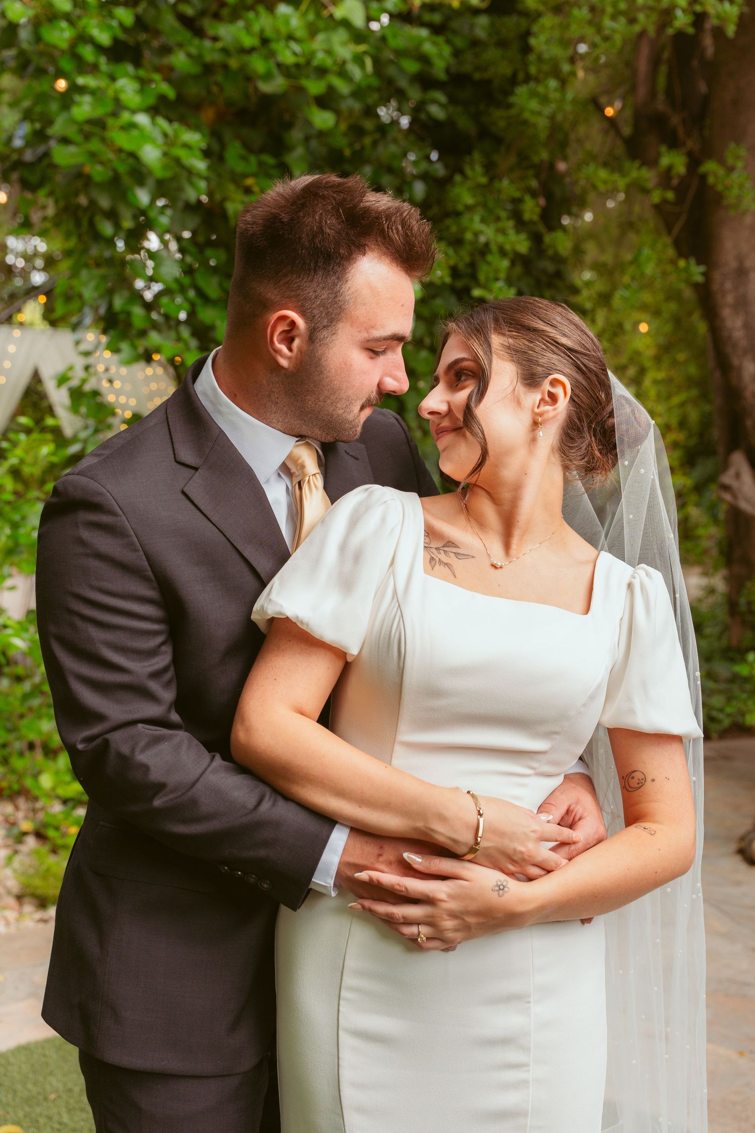 Candid wedding photos showing tender moments between a bride in white and groom in black.