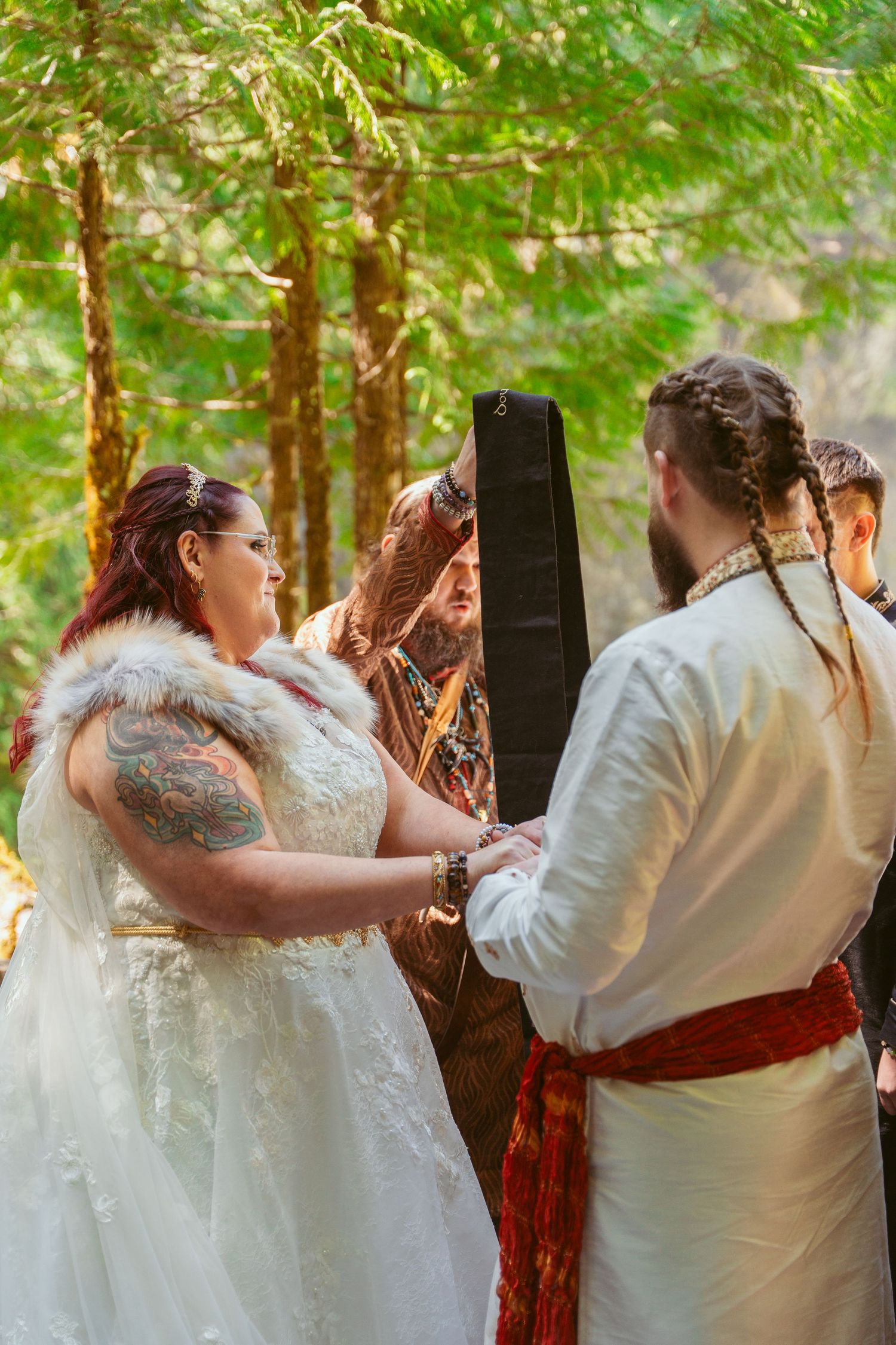 Romantic dance sequence at an outdoor forest wedding with guests looking on.