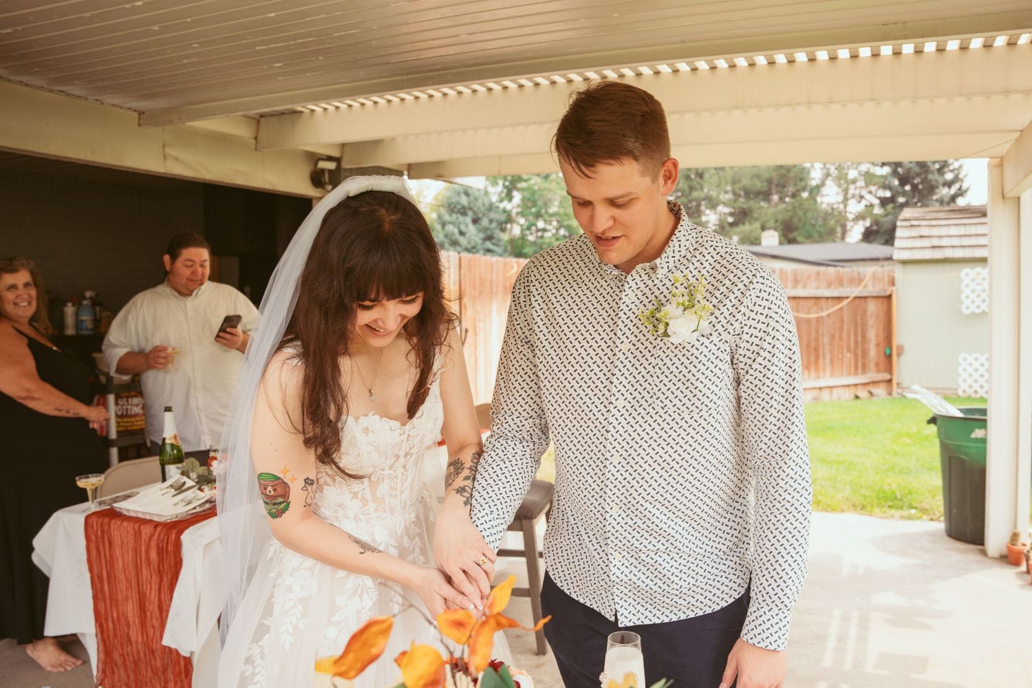 Casual outdoor celebration moments under a covered patio with natural lighting.