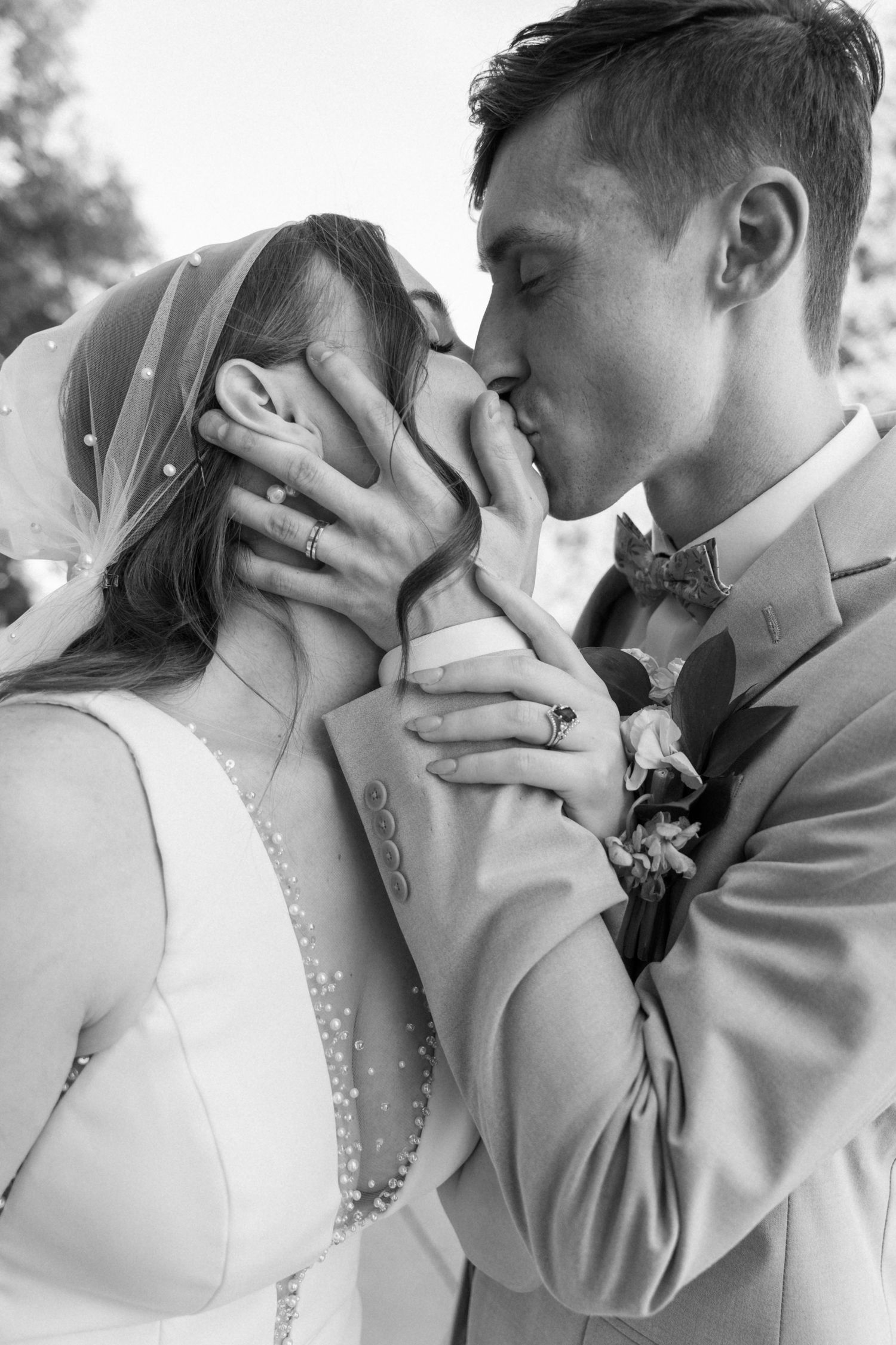 Intimate black and white wedding portraits capturing romantic moments between newlyweds.