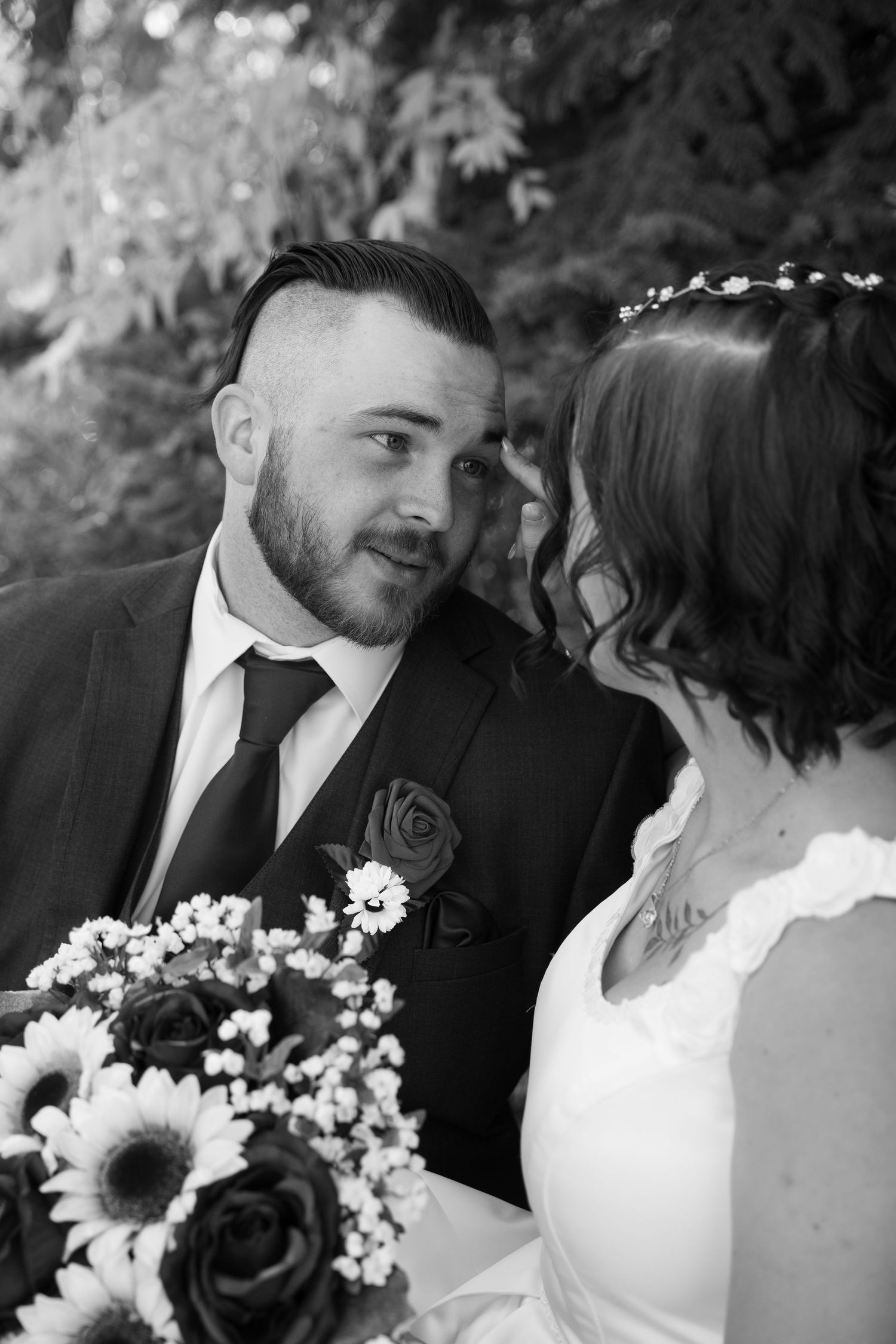 Black and white wedding portraits featuring sunflower bouquet and romantic poses.