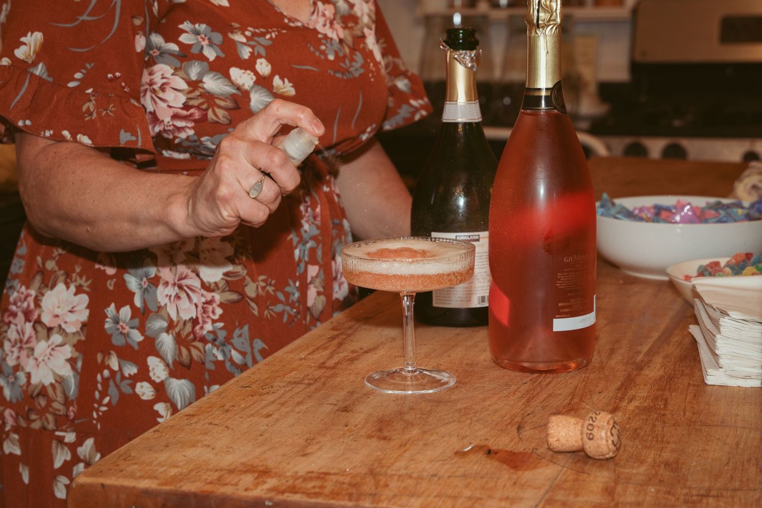 Wedding reception details with champagne glasses and decorations on a rustic wooden table.