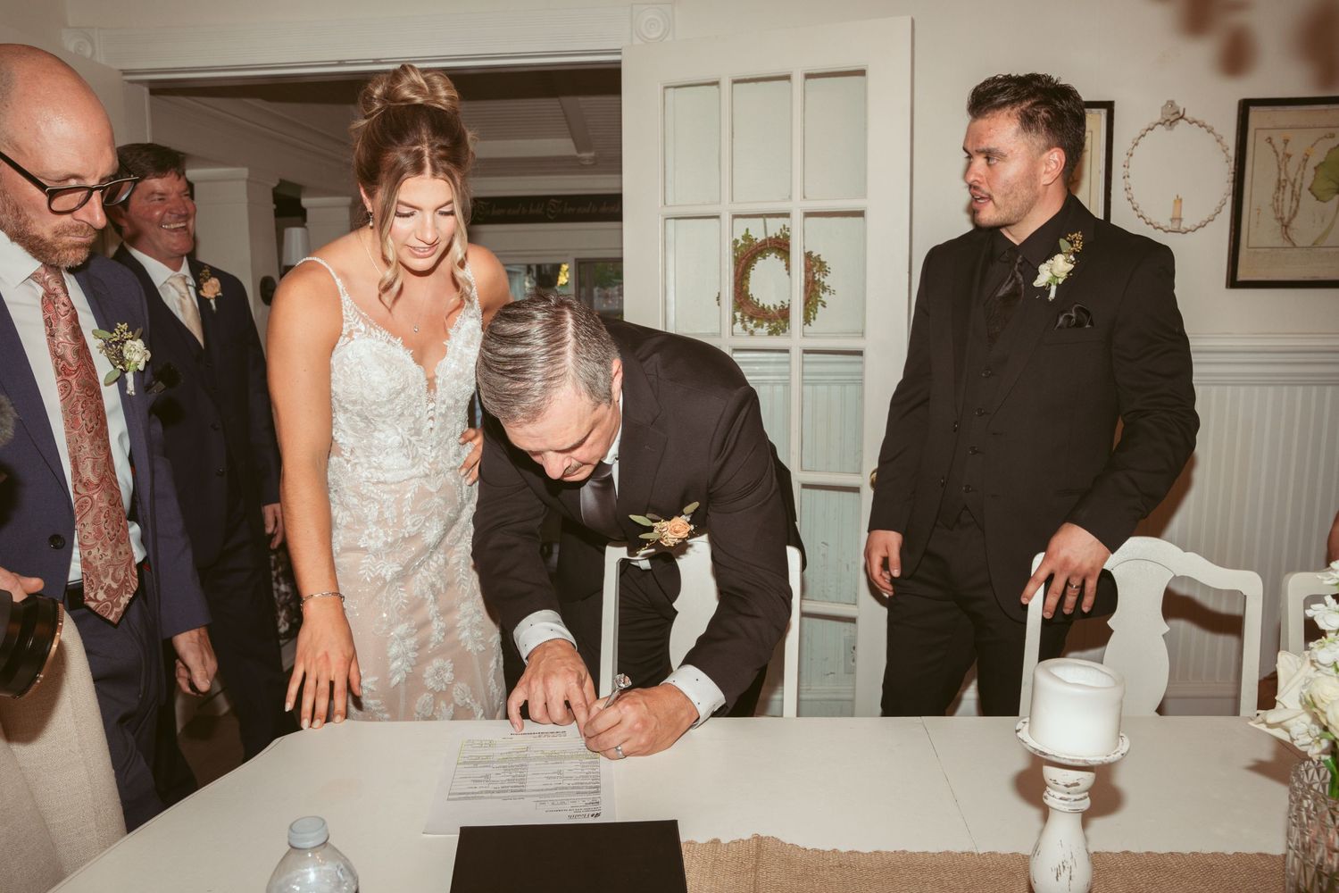 Wedding reception candids showing guests celebrating in an elegant indoor venue.