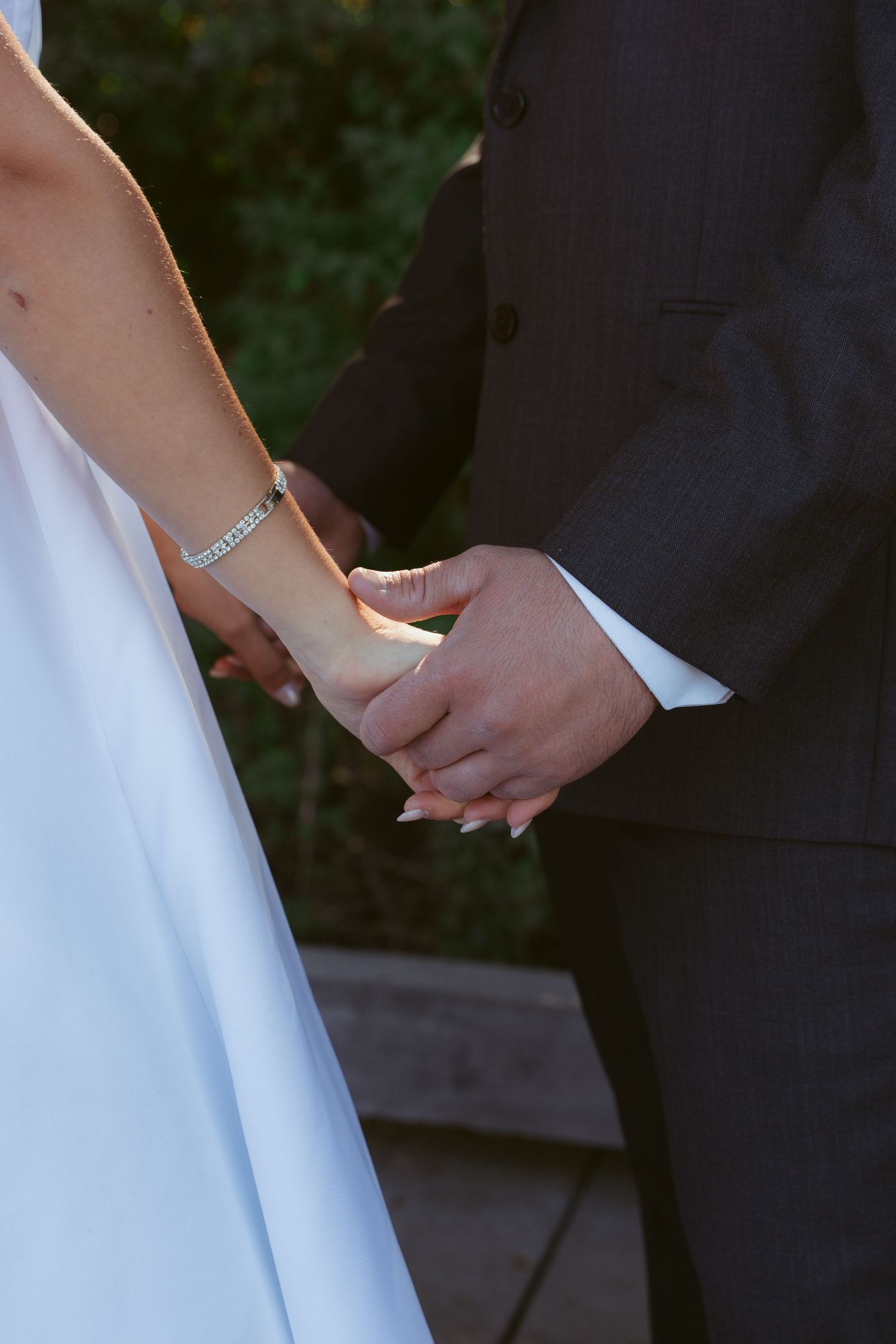 Close-up shot of hands holding during a wedding ceremony.