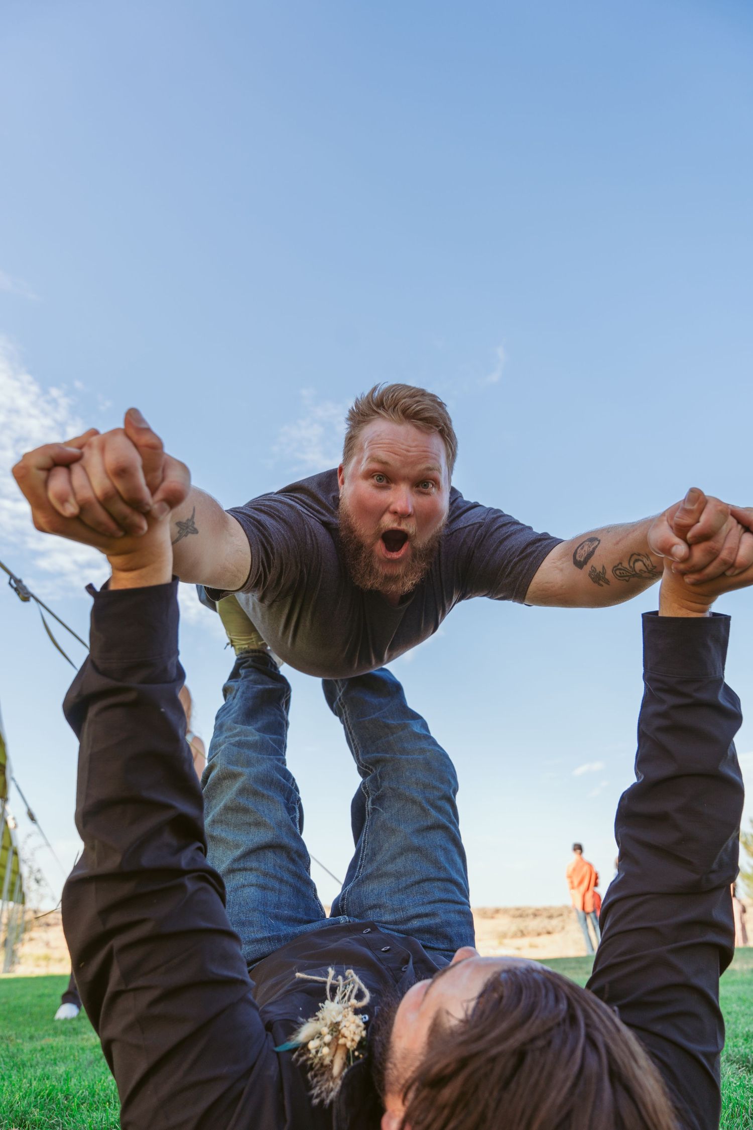 A sequence of playful wedding photos showing a couple performing dramatic dips on an outdoor lawn.