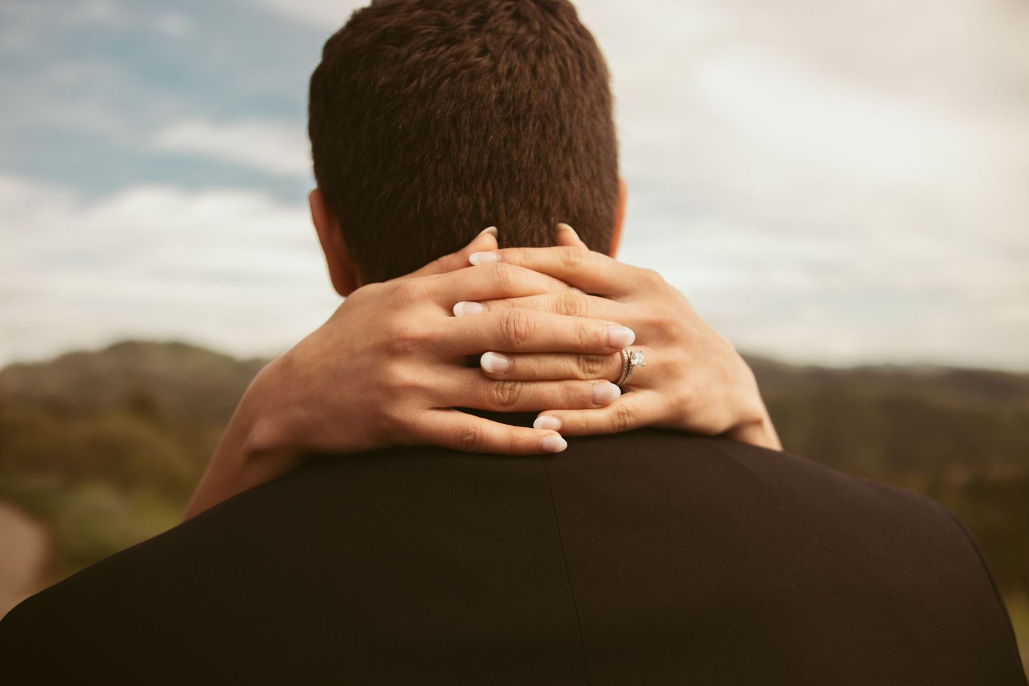 Close-up shots of hands embracing during an intimate wedding moment.