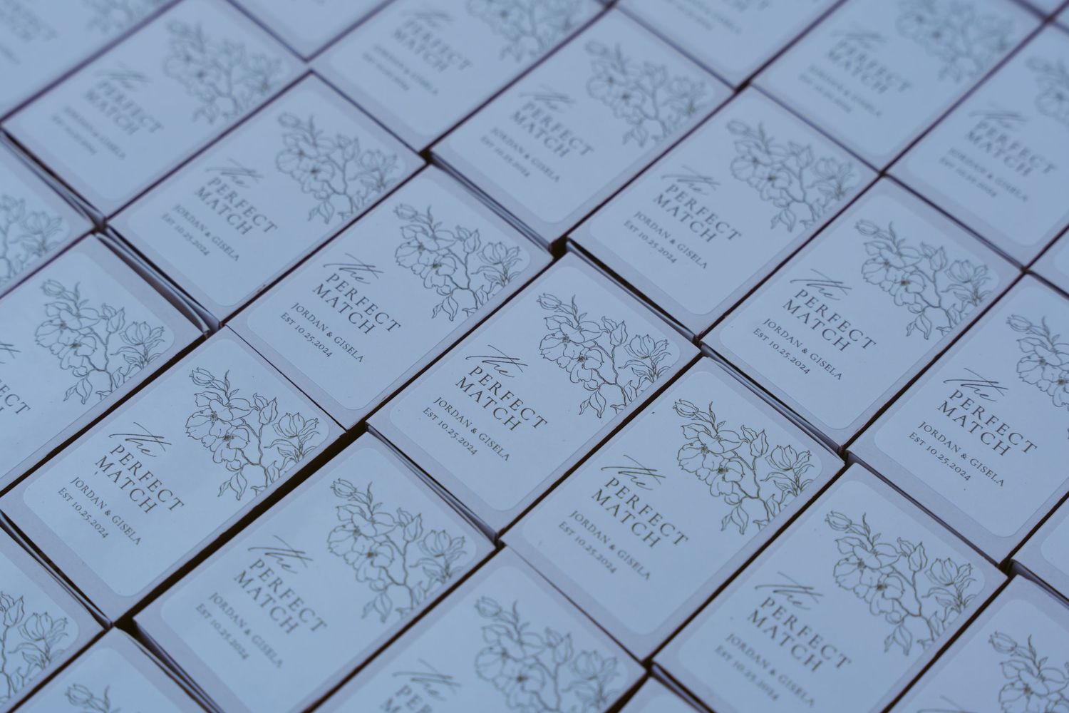 Rows of identical white paper cards or invitations arranged in a geometric pattern.