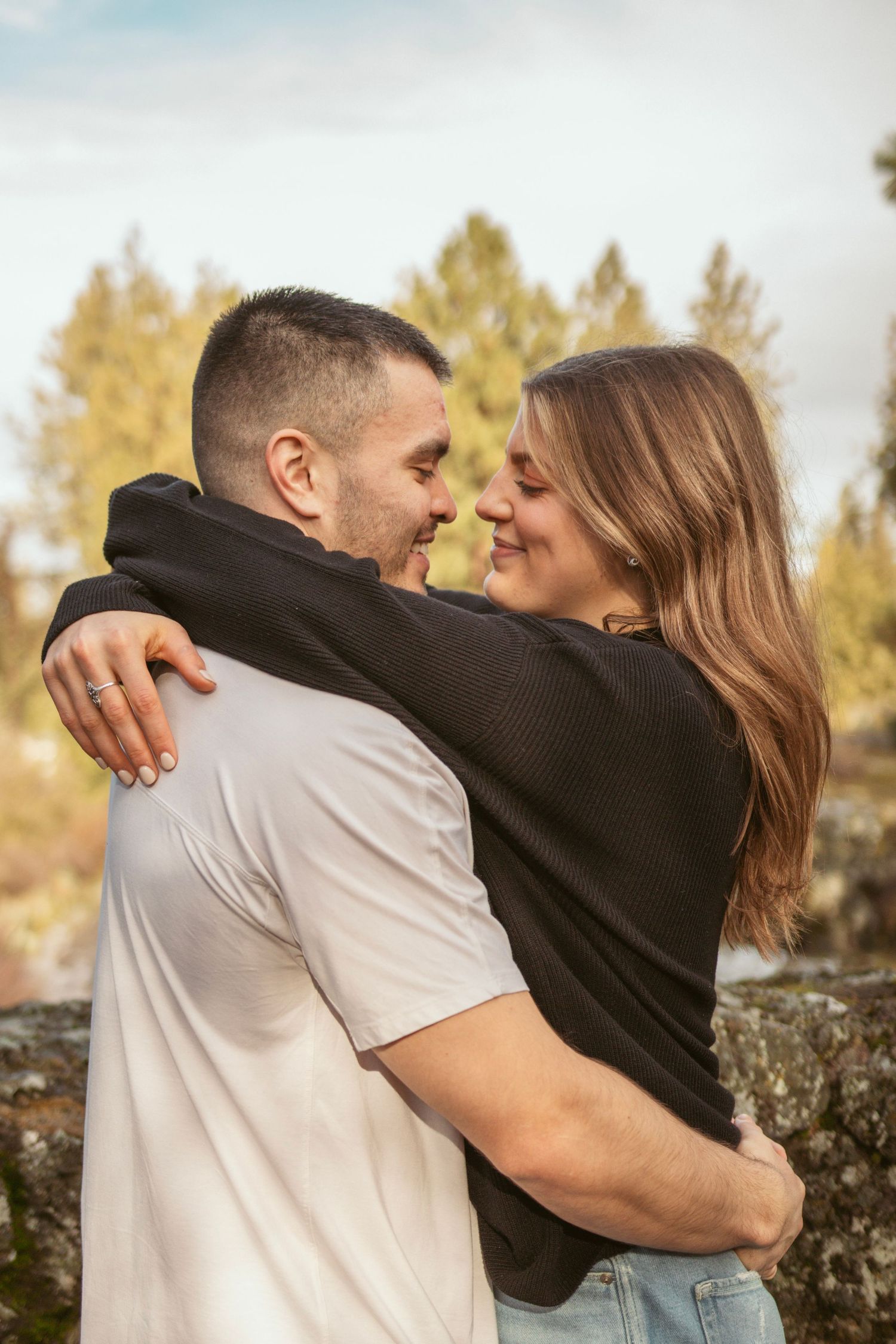 A romantic couple embraces and shares intimate moments in a series of outdoor photos.