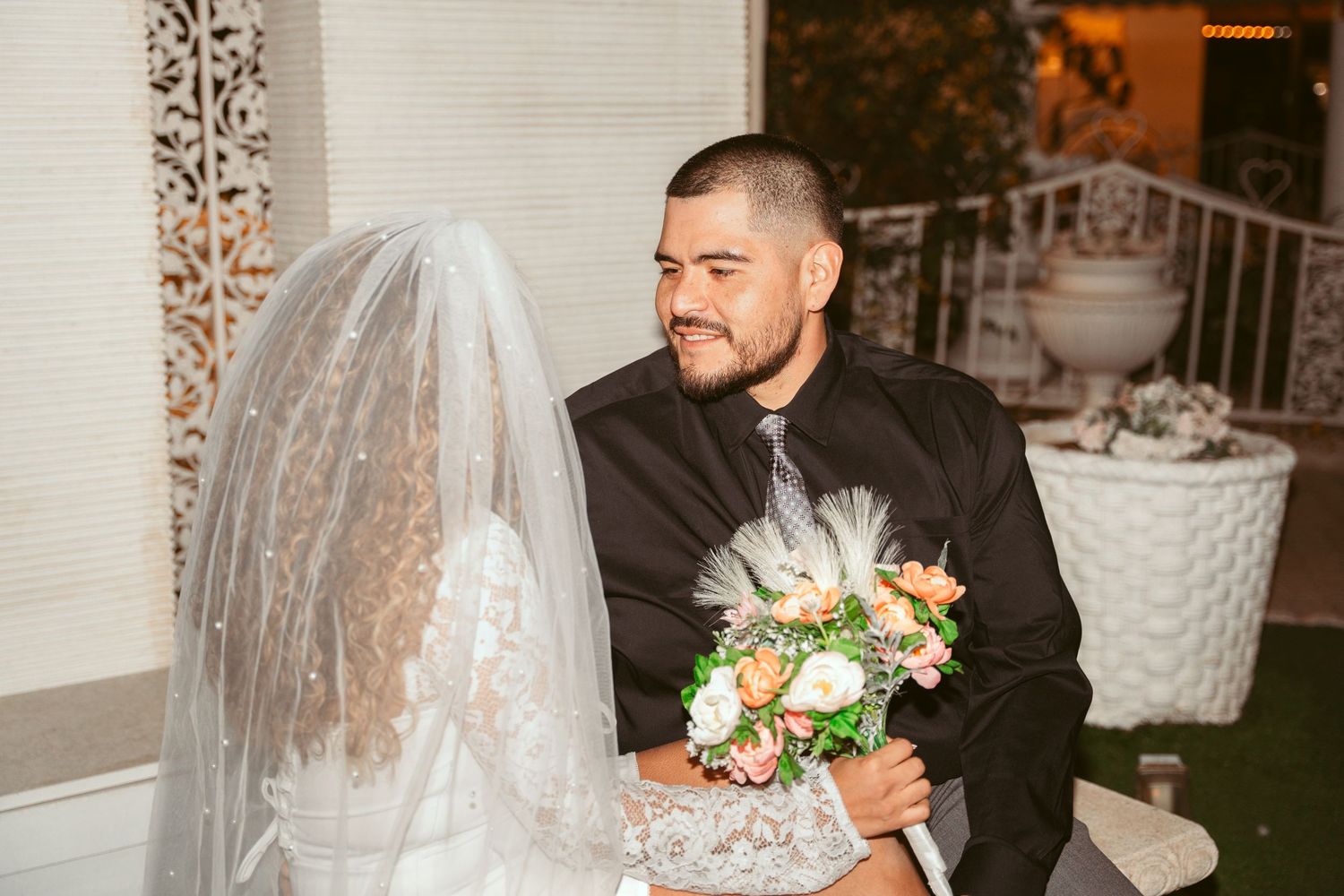 A couple embraces during their wedding ceremony at a chapel.
