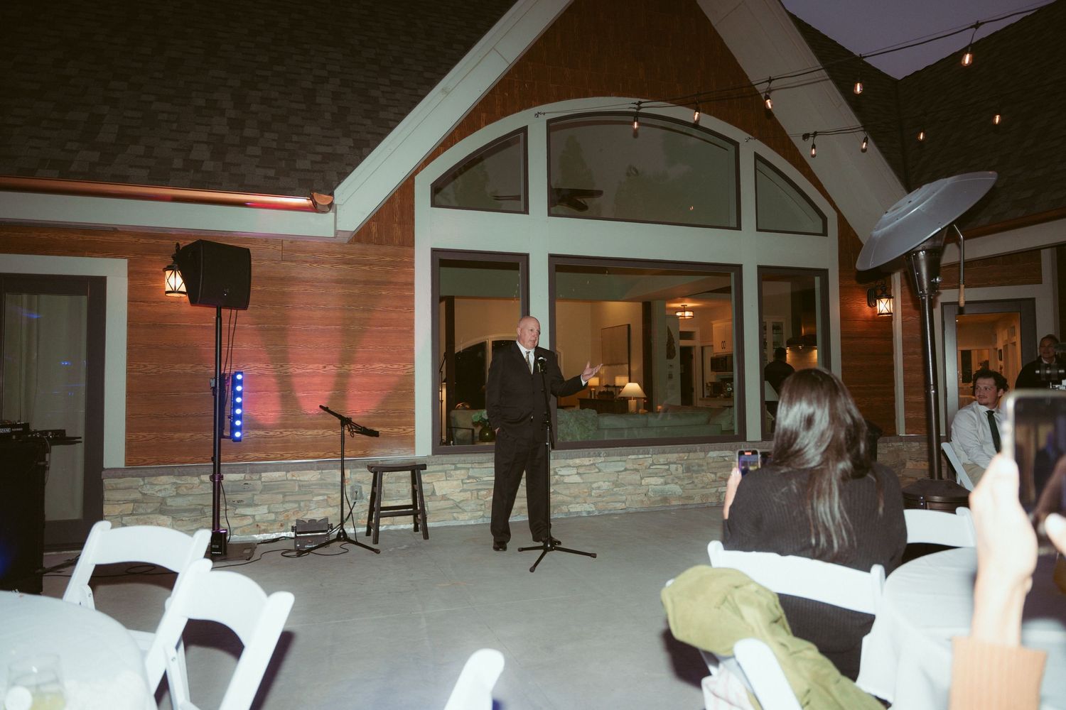 Modern venue exterior with glass windows and architectural features at dusk.