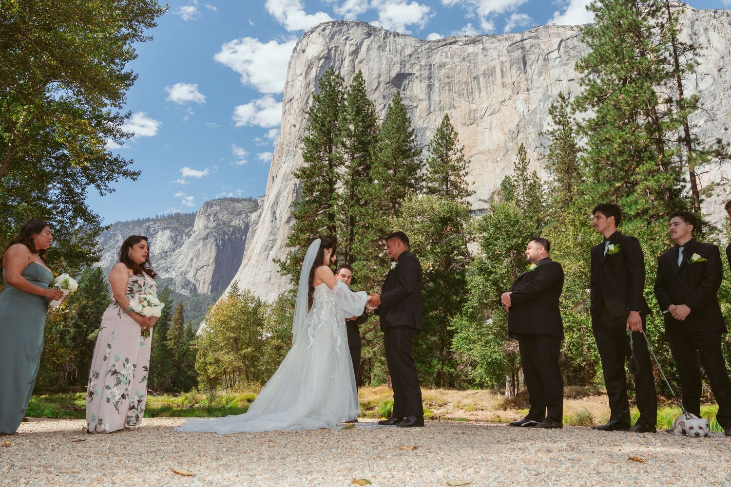 Sunny outdoor wedding ceremony with blue skies and Yosemite's Half Dome in view.