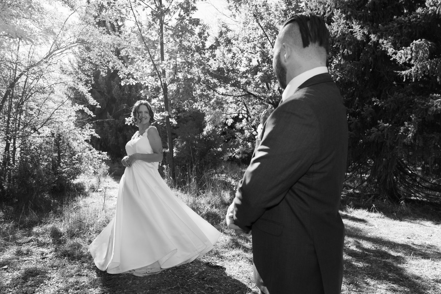 Black and white wedding photos showing couple's romantic moments in natural setting.