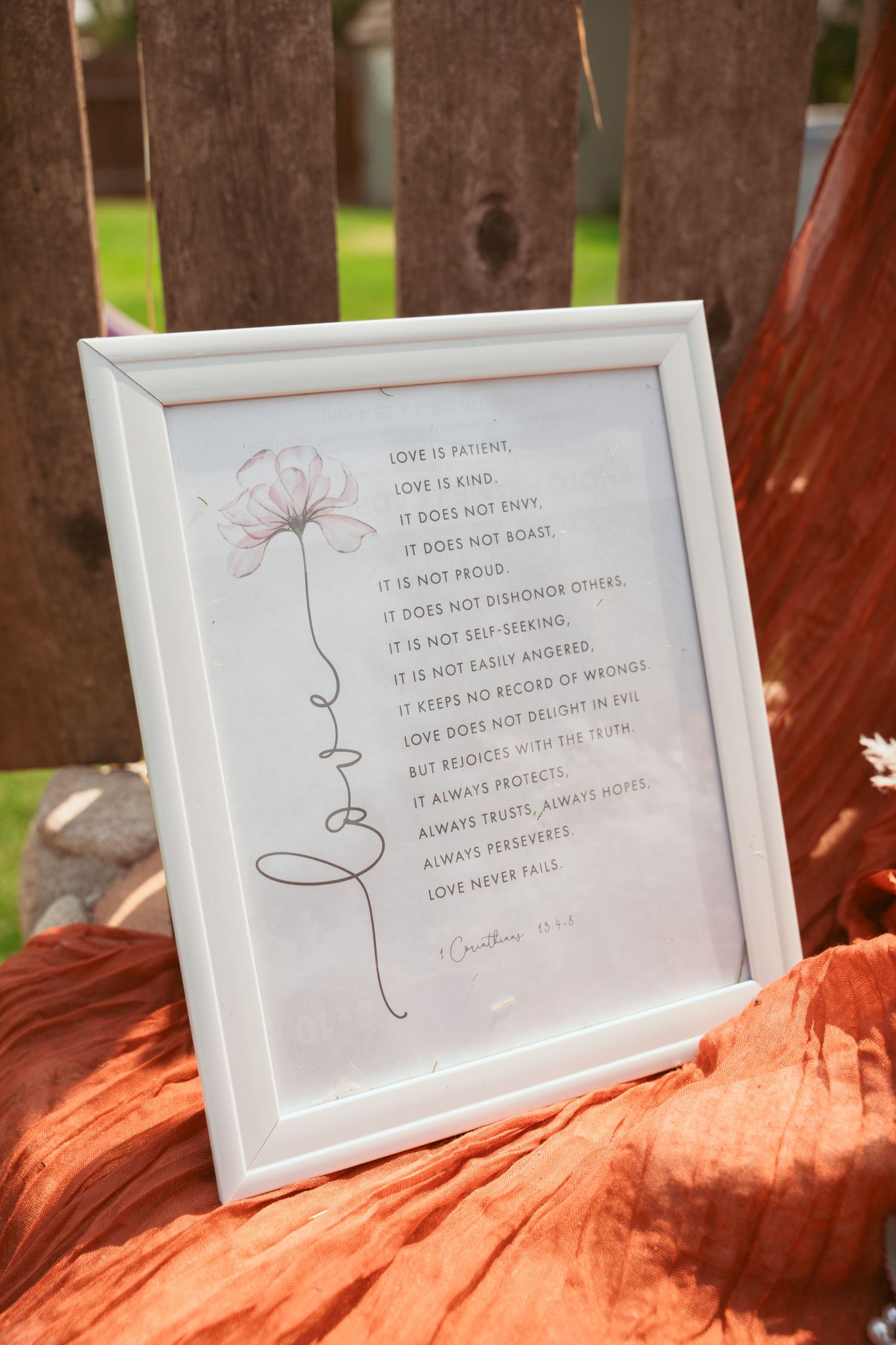 Framed wedding quotes and text displayed on an orange-tinted surface.