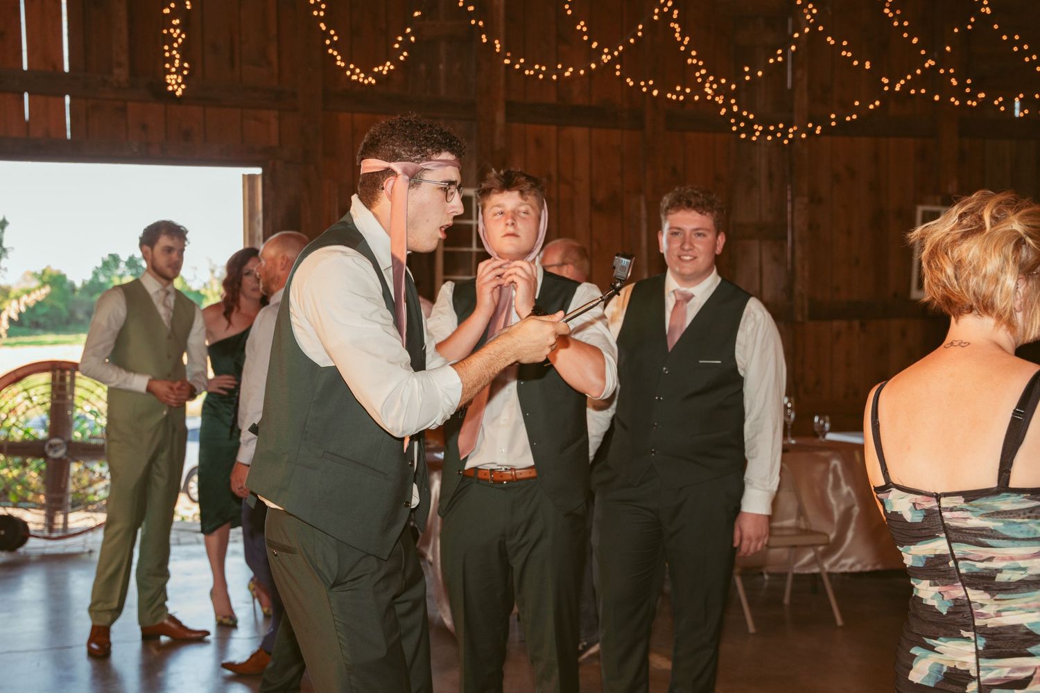 Wedding reception dance floor with string lights and paper lanterns creating a warm atmosphere.