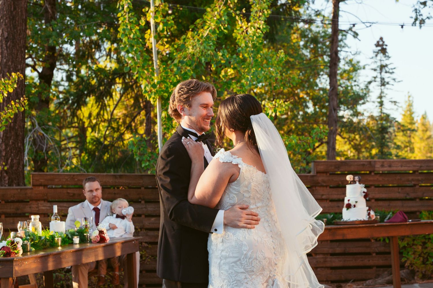Elegant dance sequence on outdoor stone patio during golden hour wedding celebration.