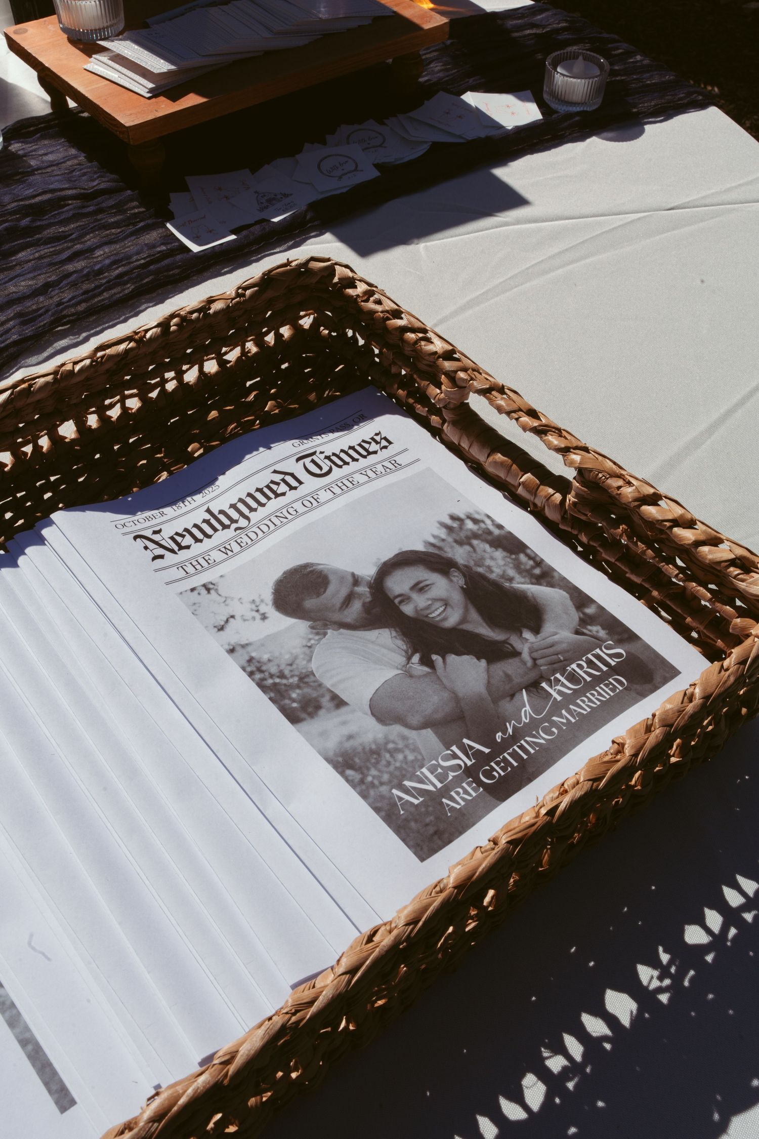 A vintage-style framed newspaper article displayed on a black and white table setting.