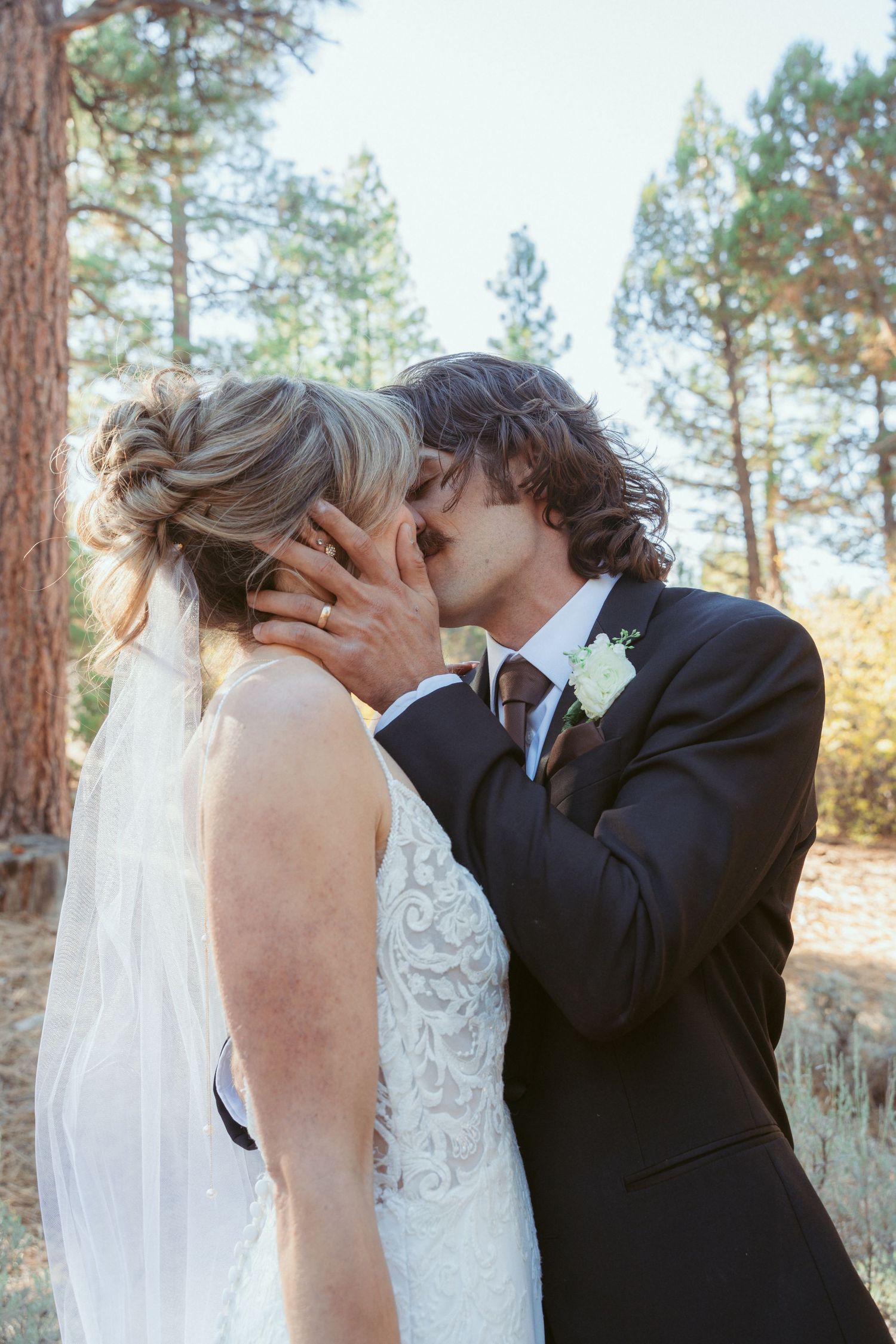 Romantic wedding photo series capturing intimate moments in a forest setting.