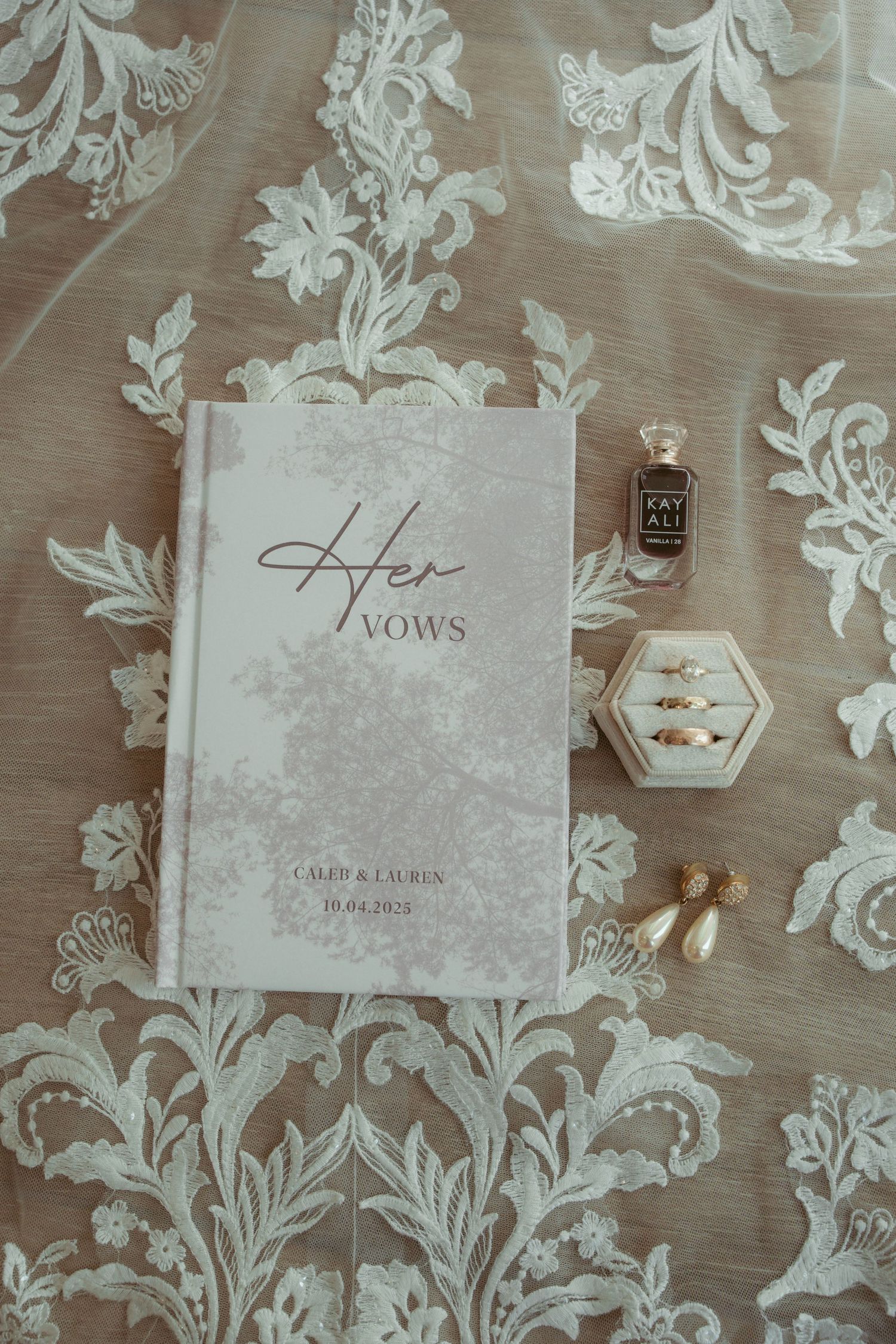 Elegant white vow books with floral pattern background for wedding ceremony.