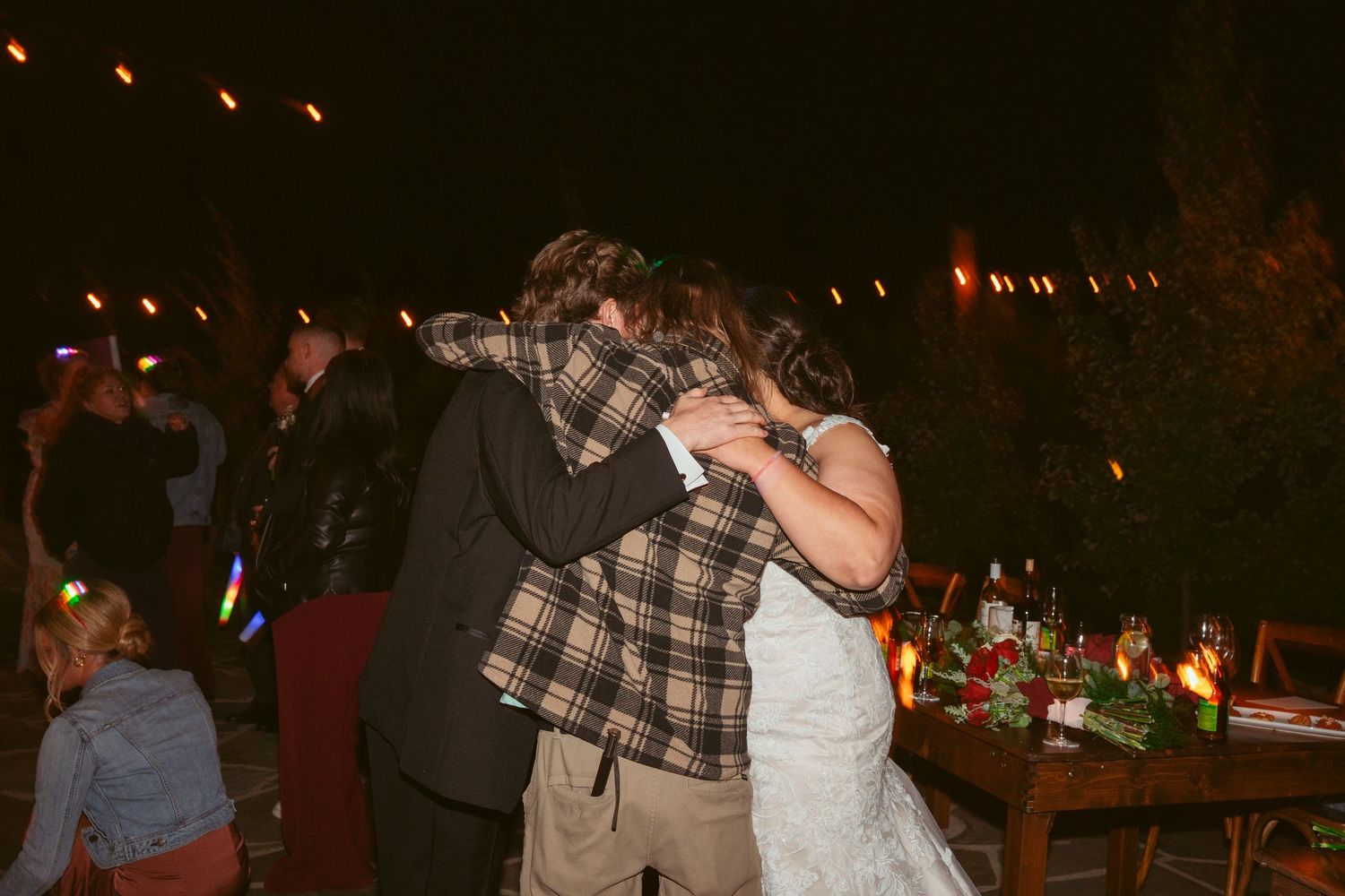 Wedding reception dance party with colorful lights and glowing decorations.