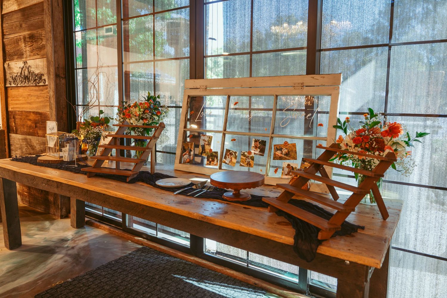 Modern restaurant interior with wooden tables and large windows letting in natural light.