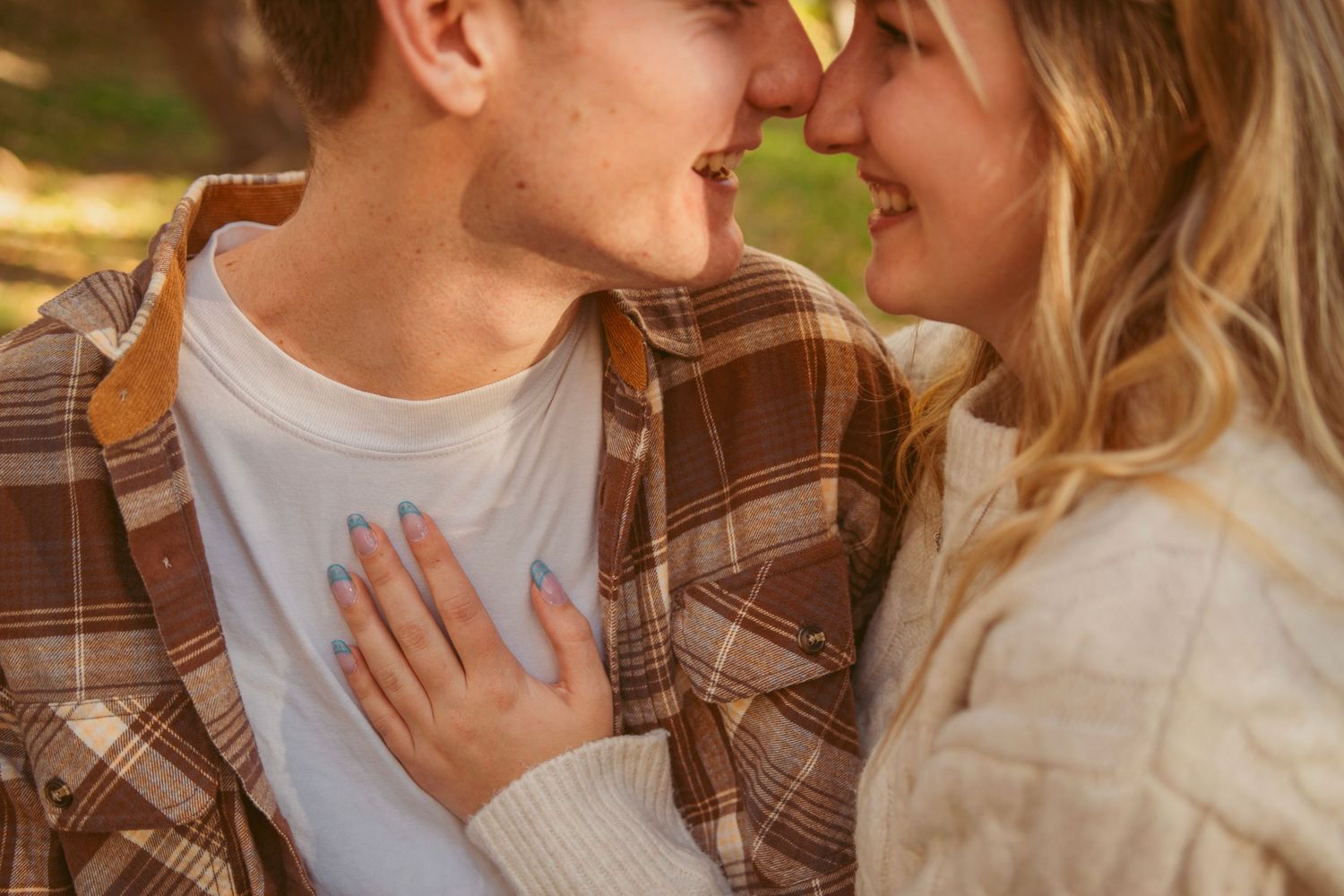 Romantic couple sharing intimate moment against golden autumn background.