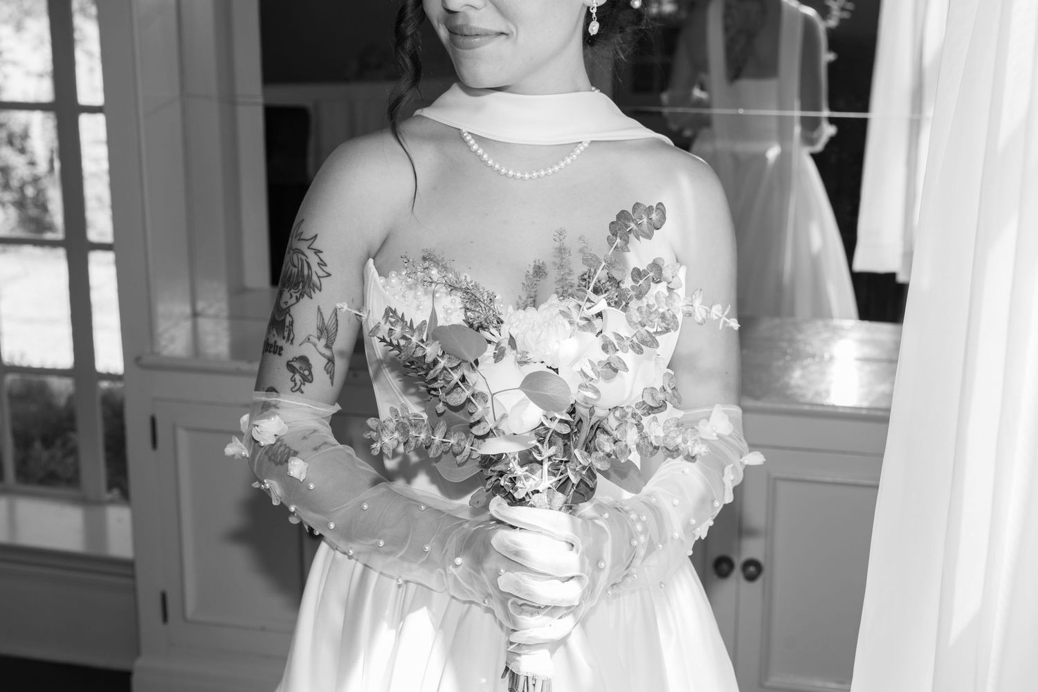 Elegant bridal details featuring lace and floral elements in soft lighting.