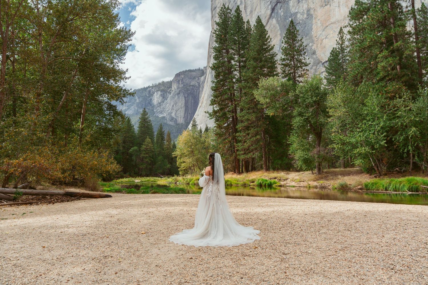 Panoramic view of Yosemite Valley with towering granite cliffs and forest landscape.
