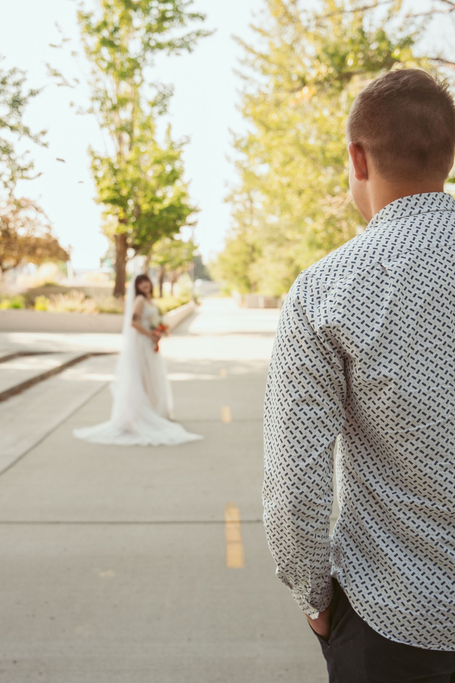 A series of wedding photos showing the first look moment between a couple outdoors on a sunny day.