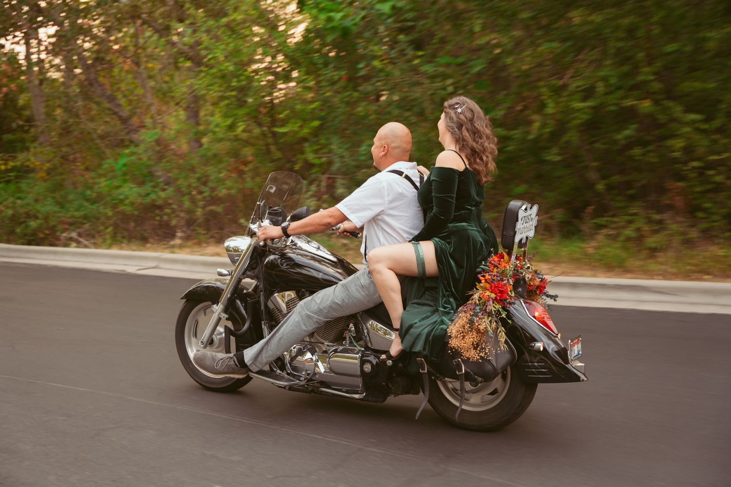 A motorcycle ride through a wooded area during sunset.