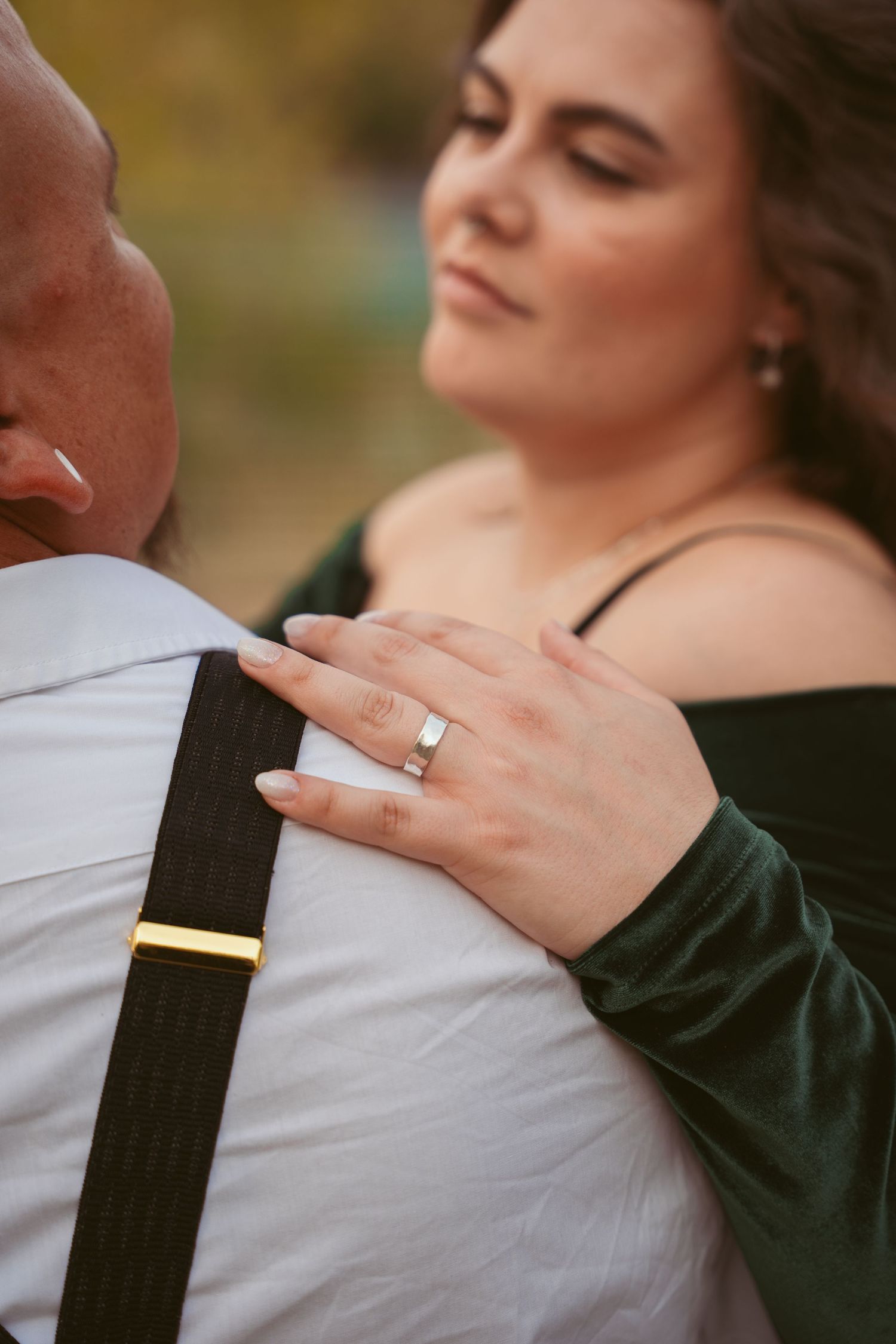 Close-up detail shots of an engagement ring during a couple's outdoor photoshoot.