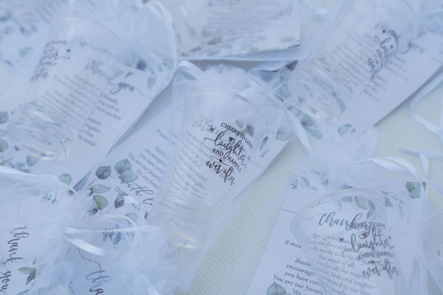 Collection of white paper wedding programs or menus arranged in an overlapping pattern.