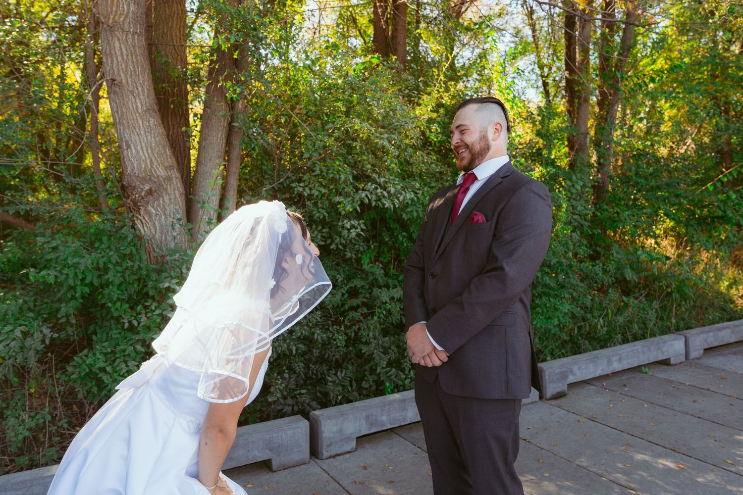 Wedding ceremony participants walking along a scenic autumn pathway.