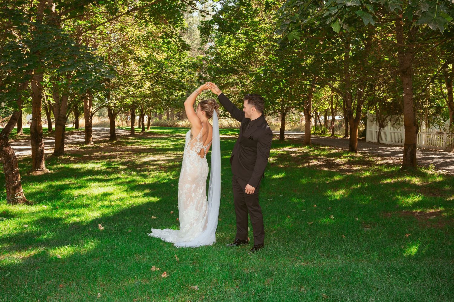 Outdoor wedding photography session in a sunlit garden setting.