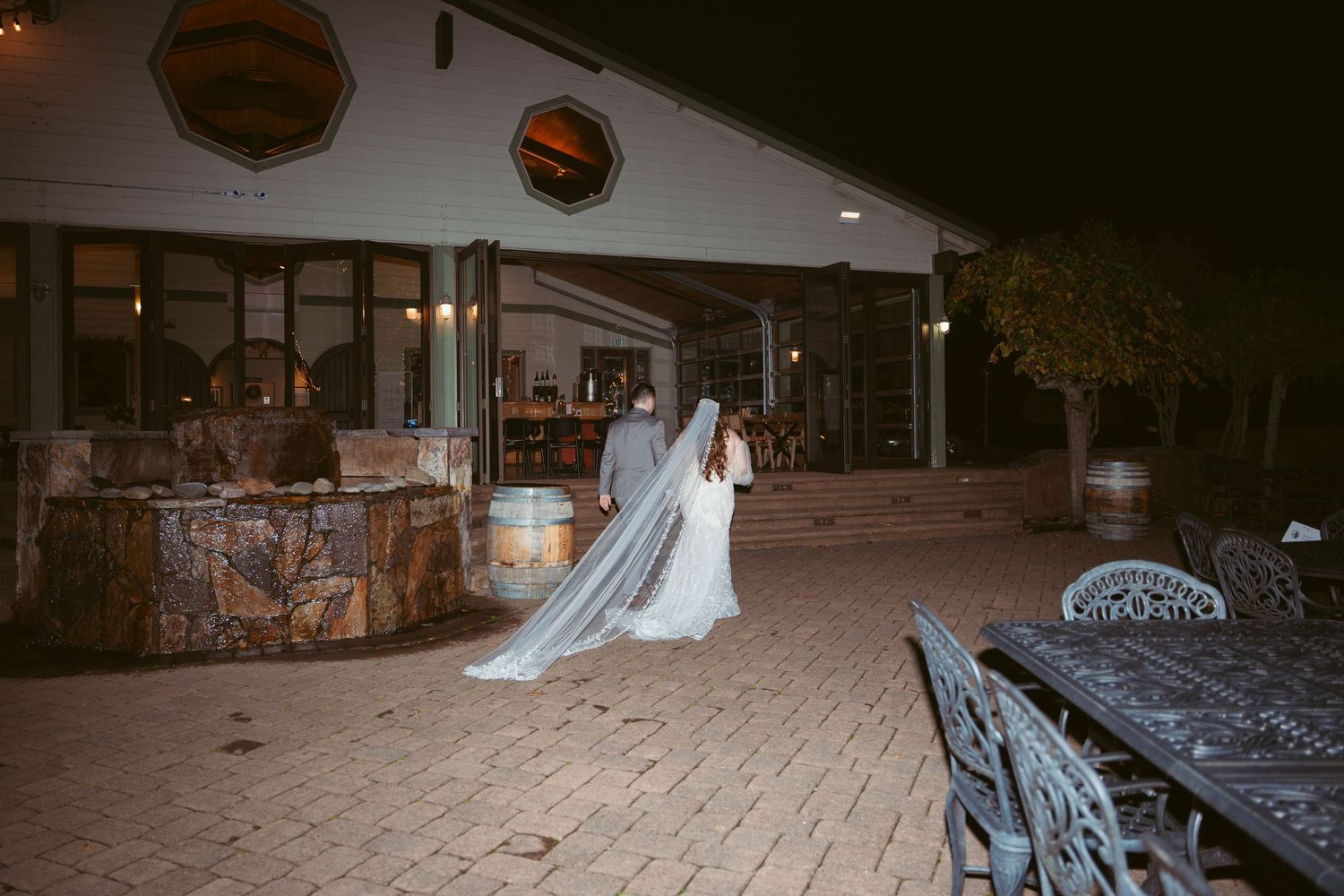 Wedding ceremony space with white decor and string lights creating a romantic ambiance.