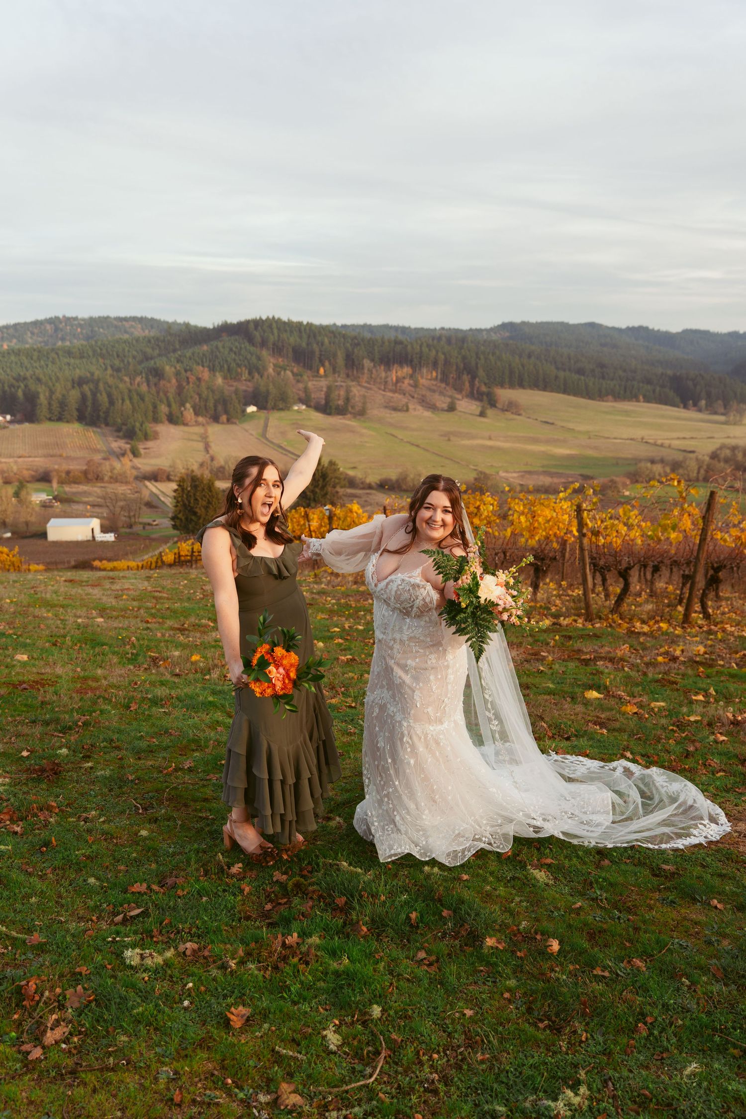 Joyful wedding photo against backdrop of autumn vineyard and rolling hills.