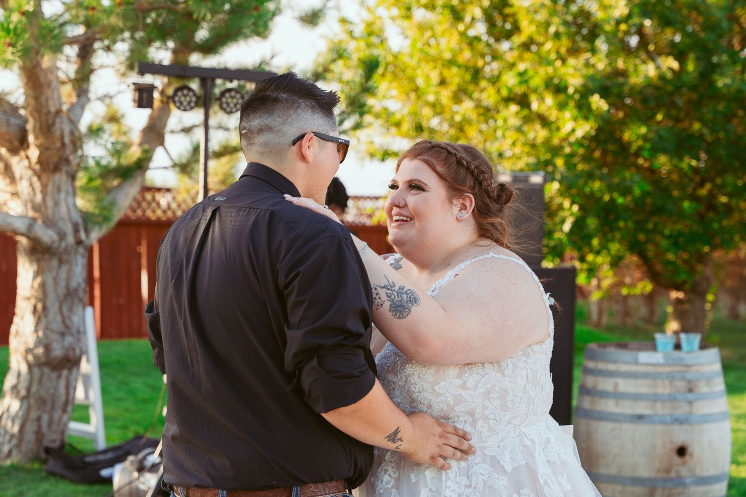 Couple sharing an intimate dance moment in a garden setting with autumn trees.
