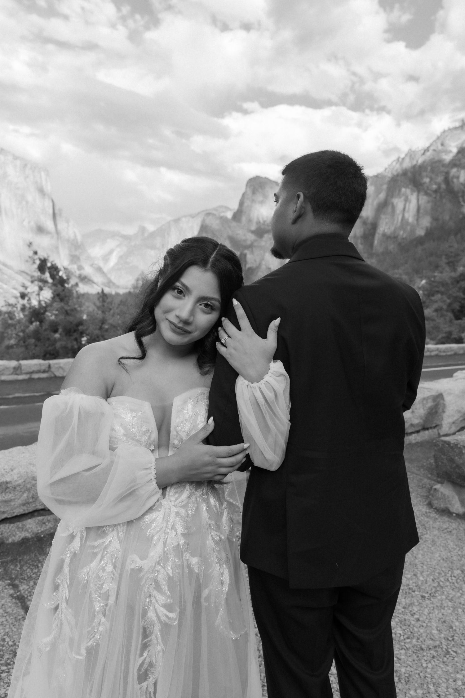 Wedding couple shares tender moments with Yosemite's iconic granite cliffs in the background.