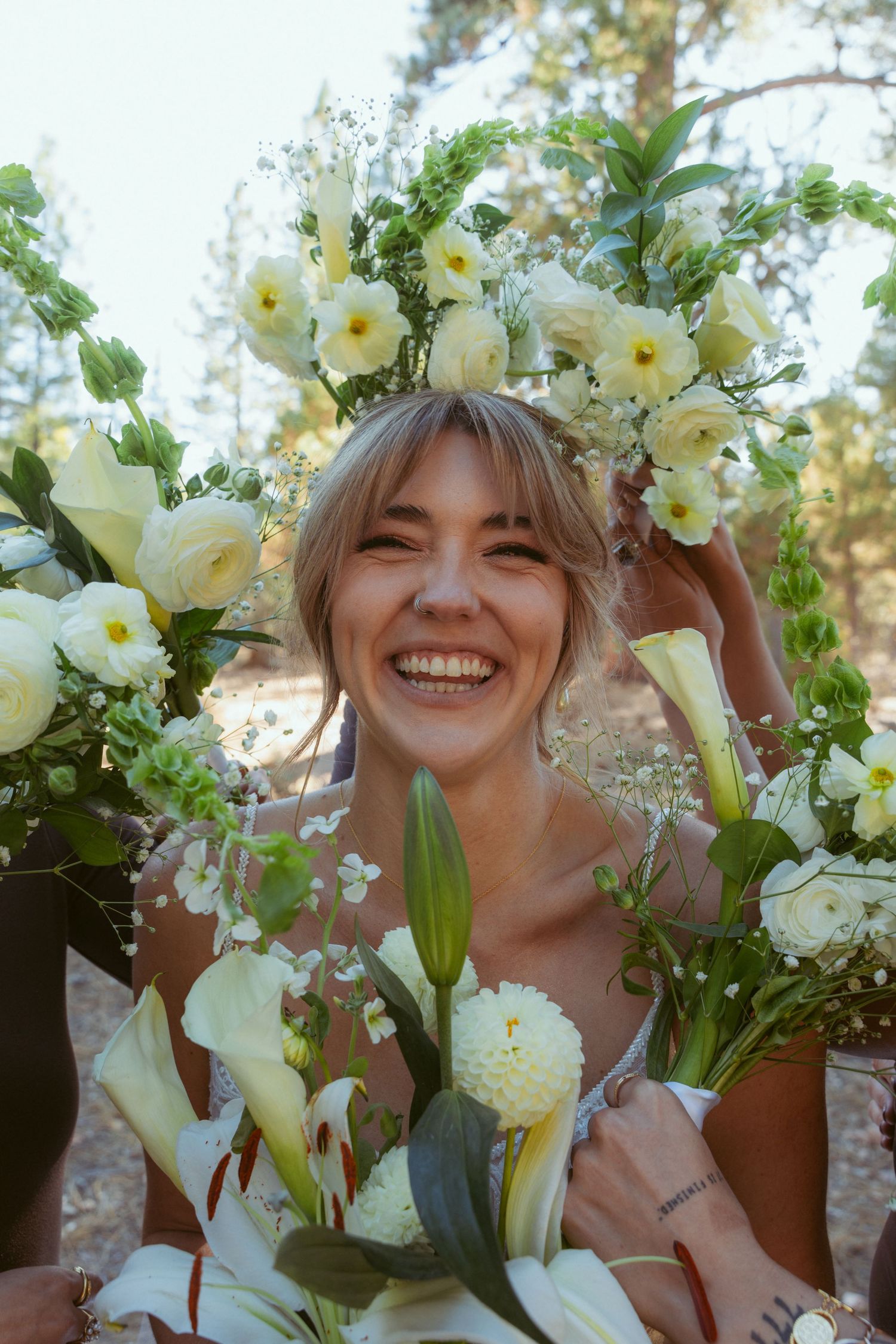 Elegant white floral arrangement featuring lilies and delicate blooms in natural light.