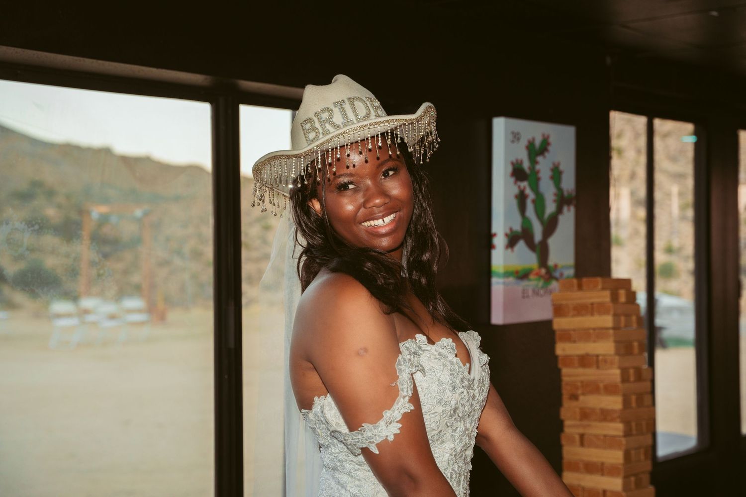 A joyful wedding celebration moment captured through a window frame.