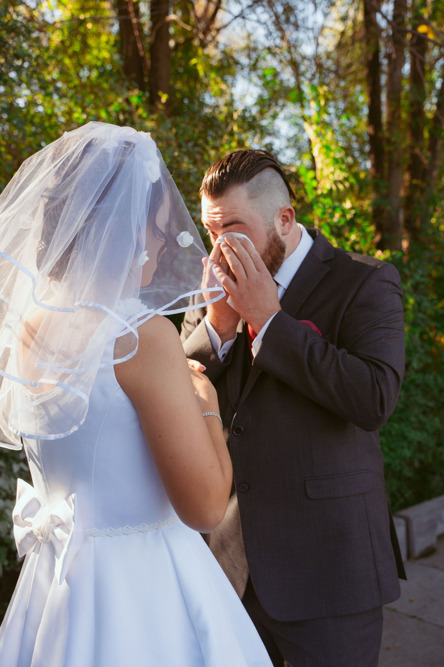 Emotional wedding photography sequence showing tender moments between newlyweds in a forest setting.