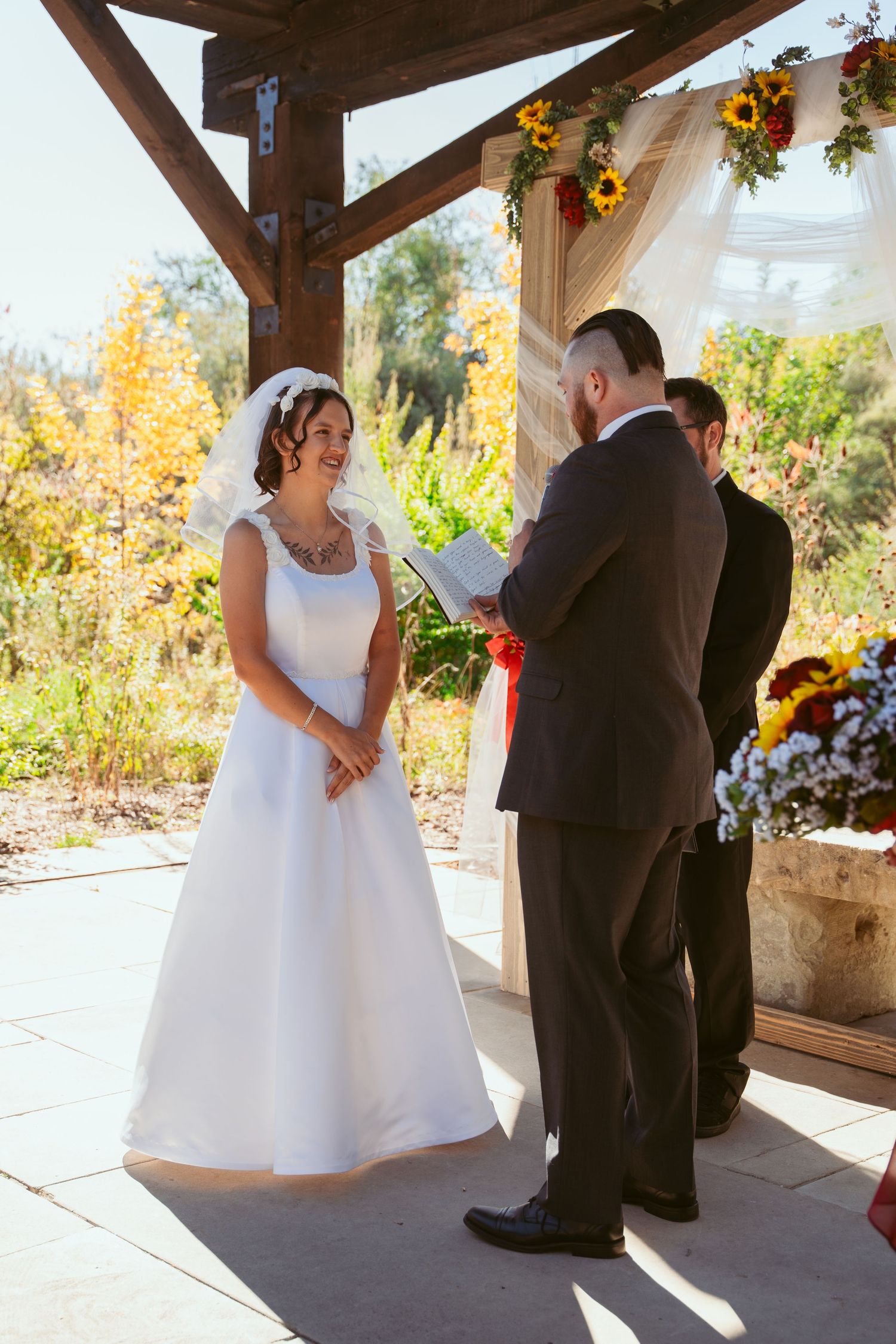 Sequence of wedding ceremony moments captured under rustic wooden pavilion with sunflowers.