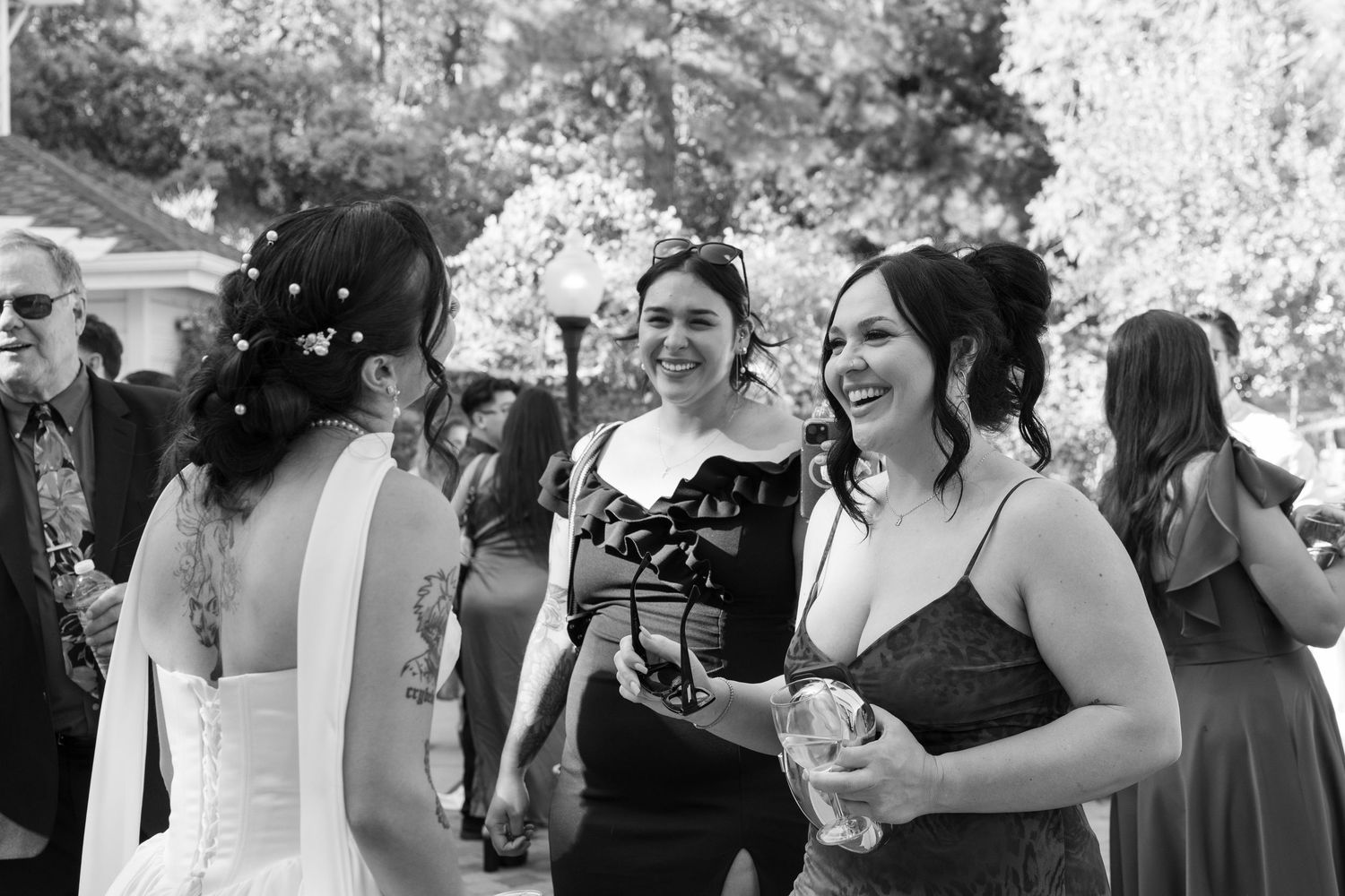 Wedding party members enjoying outdoor celebrations in formal attire.