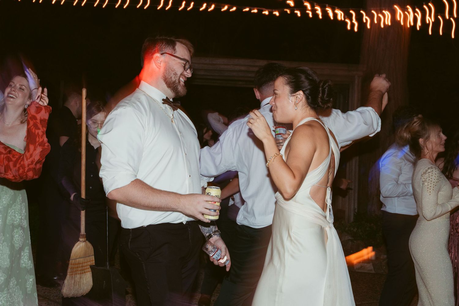 A series of couples dancing together at a dimly lit wedding reception or party venue.