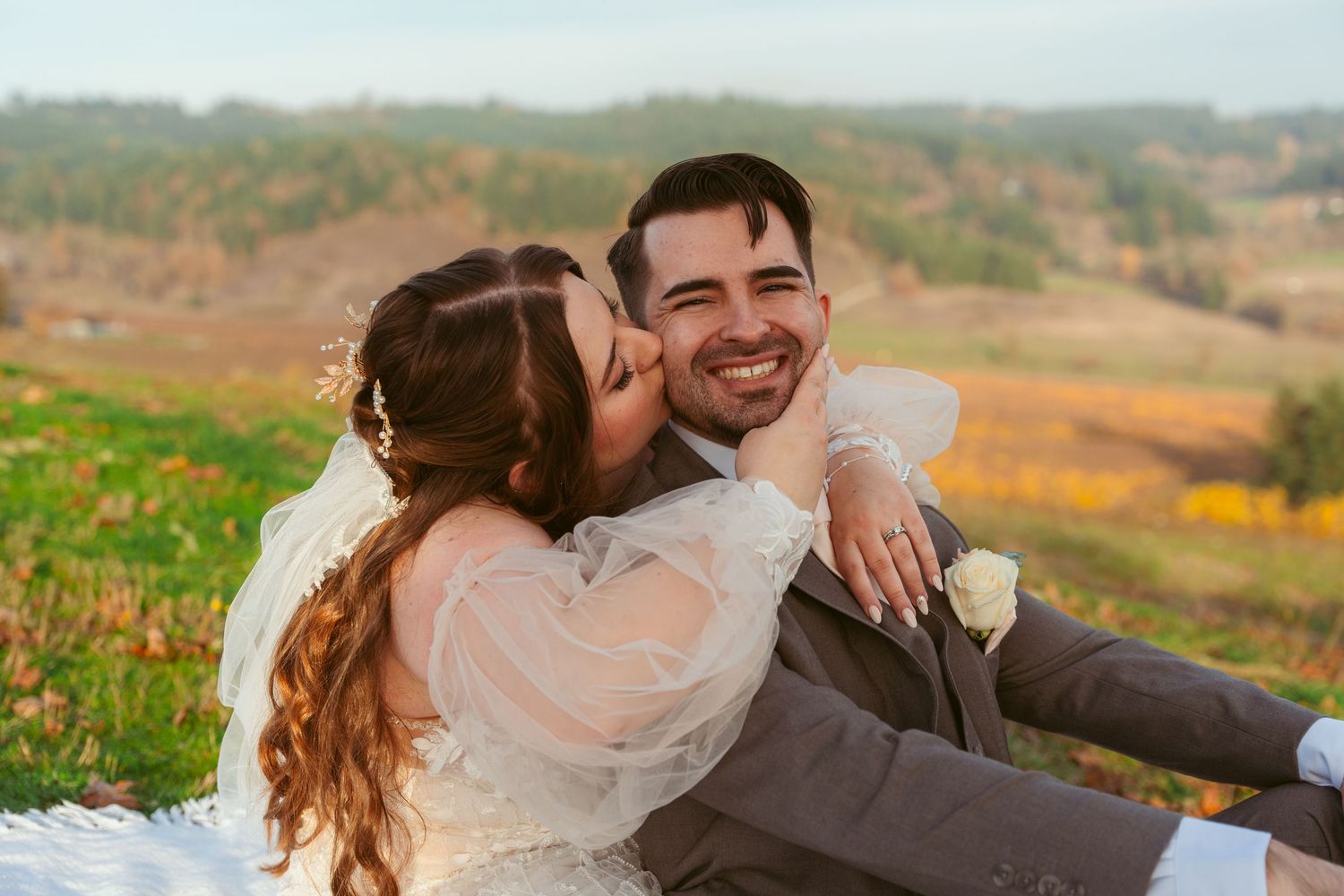 A romantic wedding photo shoot in a scenic mountainous landscape with autumn colors.