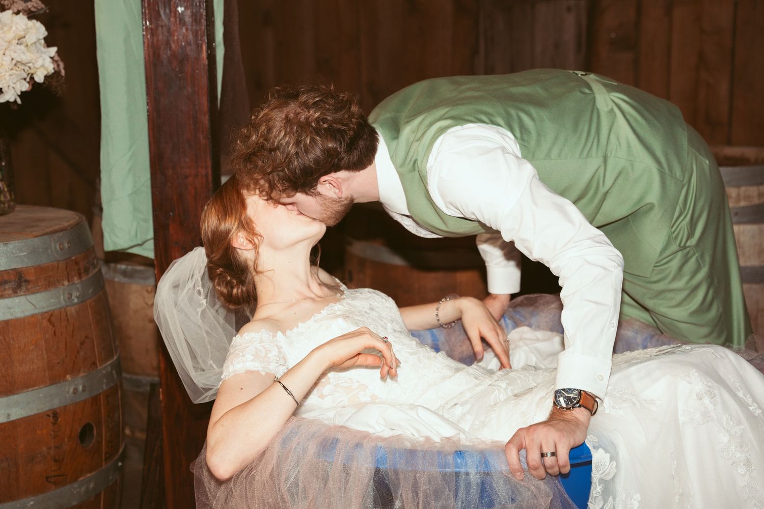A couple performs a dramatic dip dance move during their wedding reception.