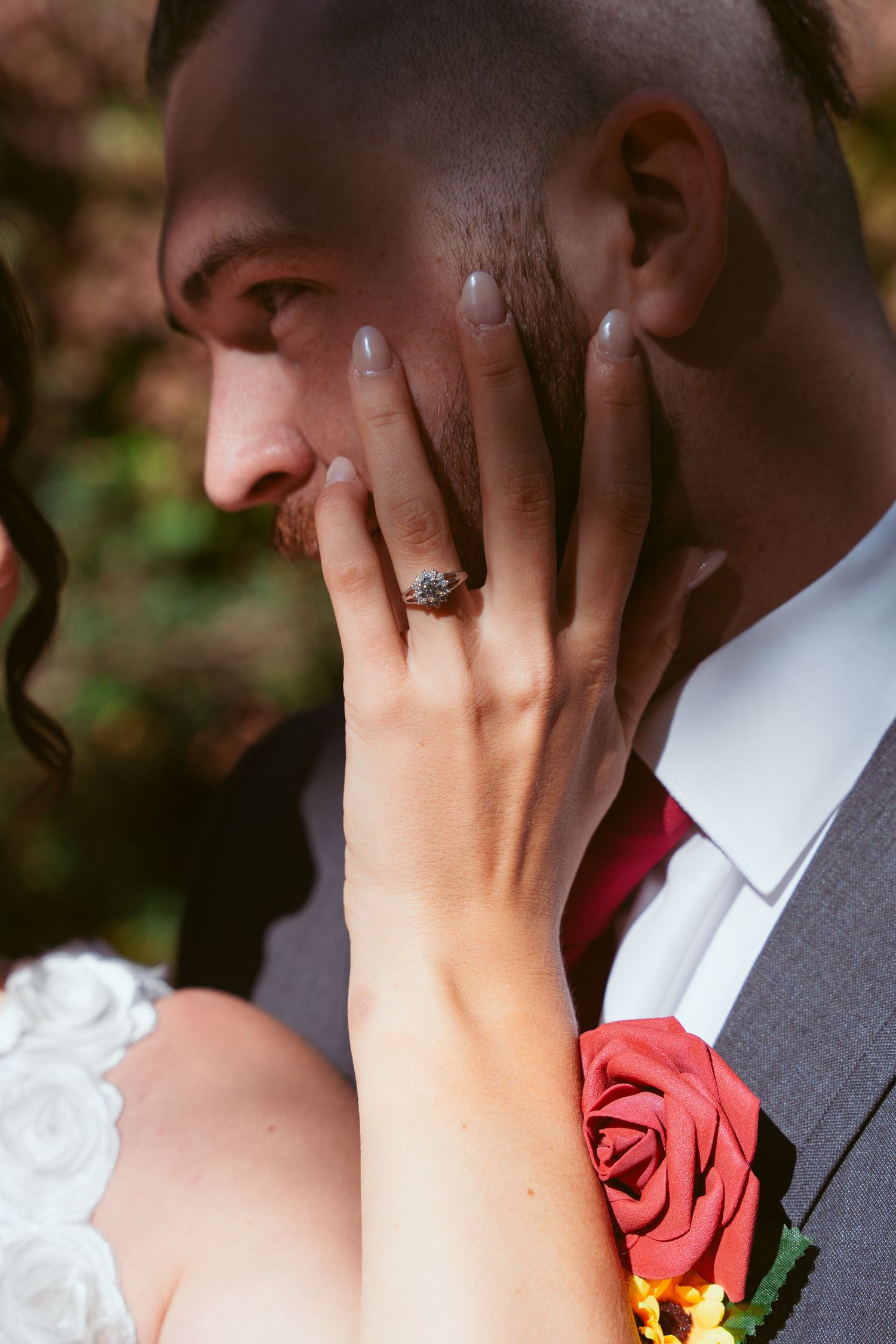 Close-up wedding photography sequence showing romantic kiss with red rose boutonniere and gray suit.
