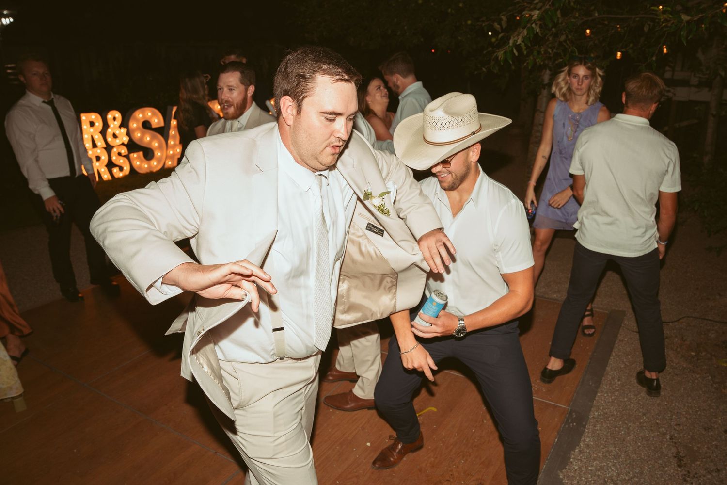 People dancing and having fun at an outdoor nighttime event.