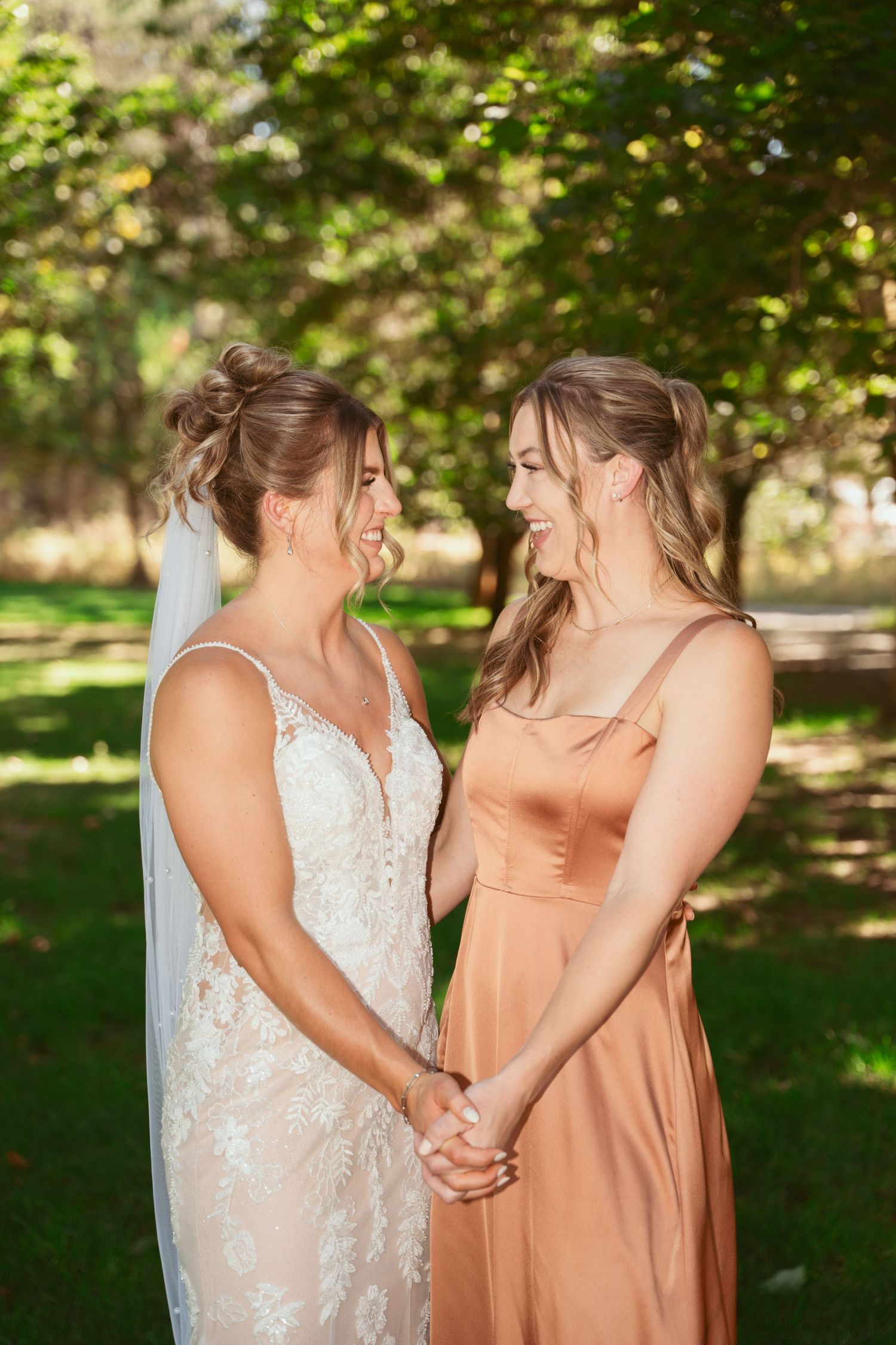 Two people in formal attire share an intimate moment outdoors.