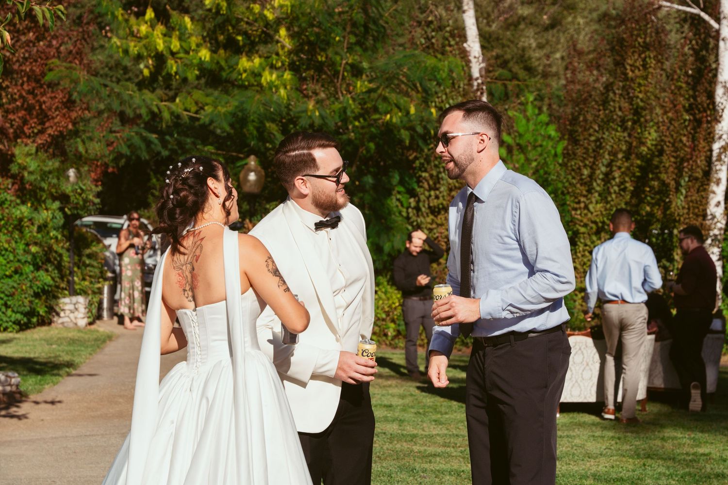 Couples dancing together at an outdoor garden wedding reception.