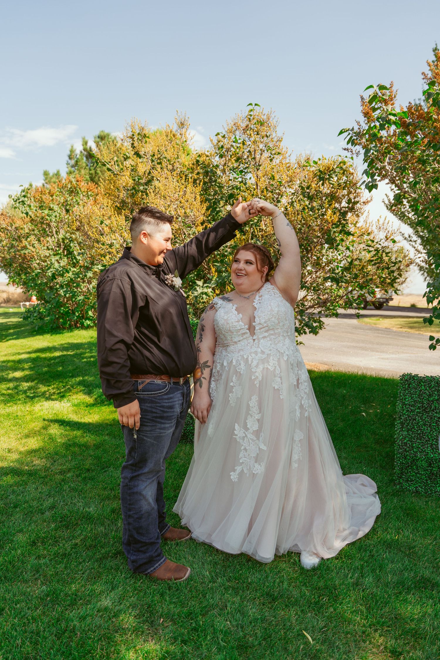 A romantic wedding photo series showing a couple dancing and embracing on a grassy lawn with trees in the background.